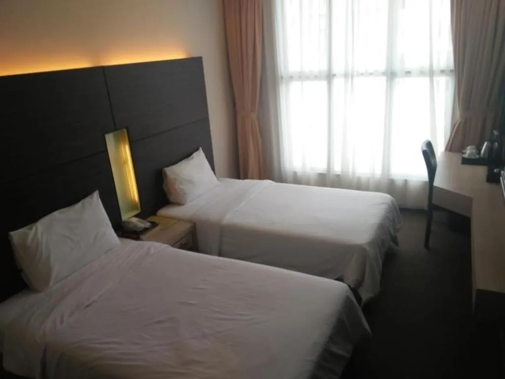 Bed in Grand Medallion Hotel