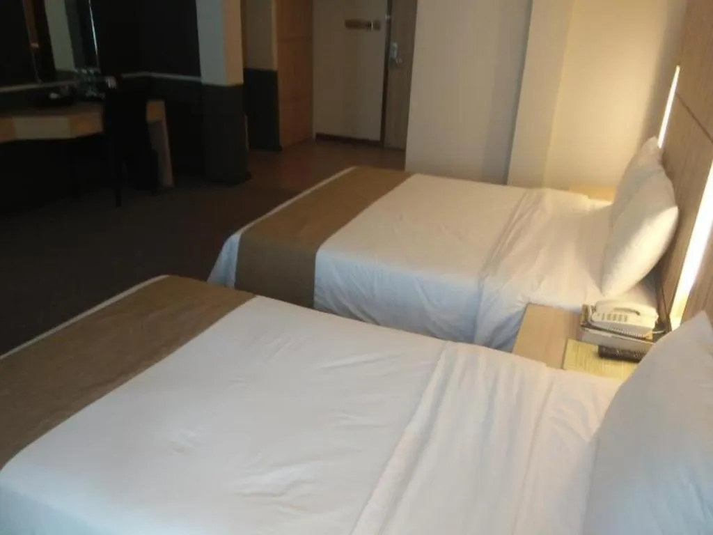 Bed in Grand Medallion Hotel