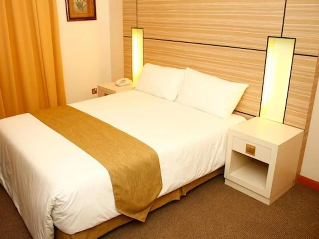 Bed in Grand Medallion Hotel