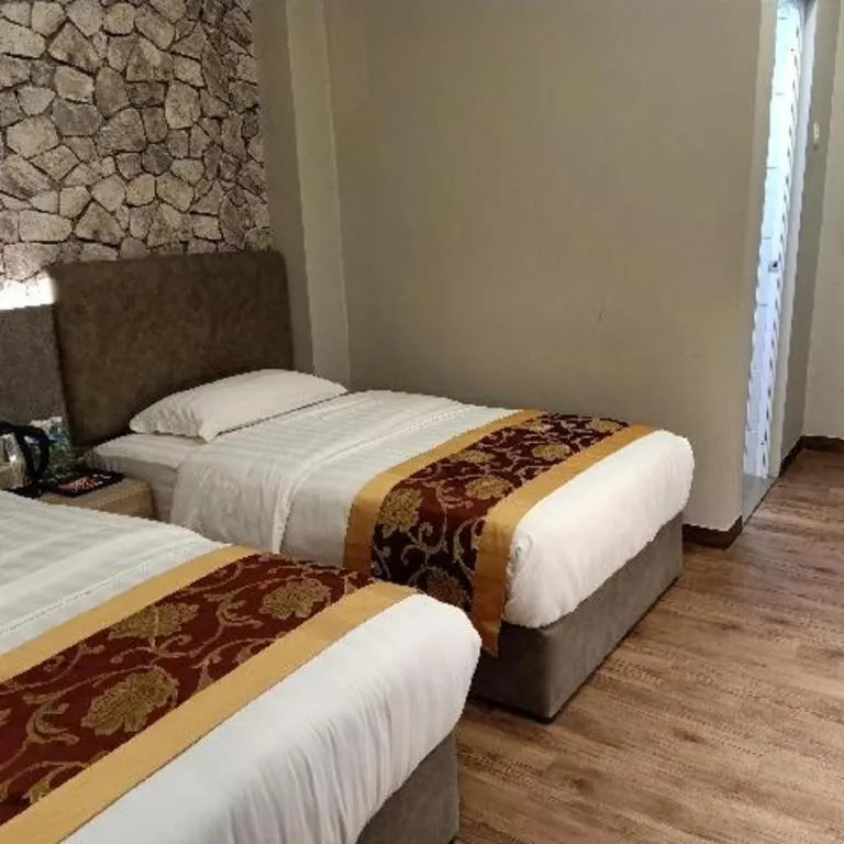 Bed in M GLOBAL HOTEL