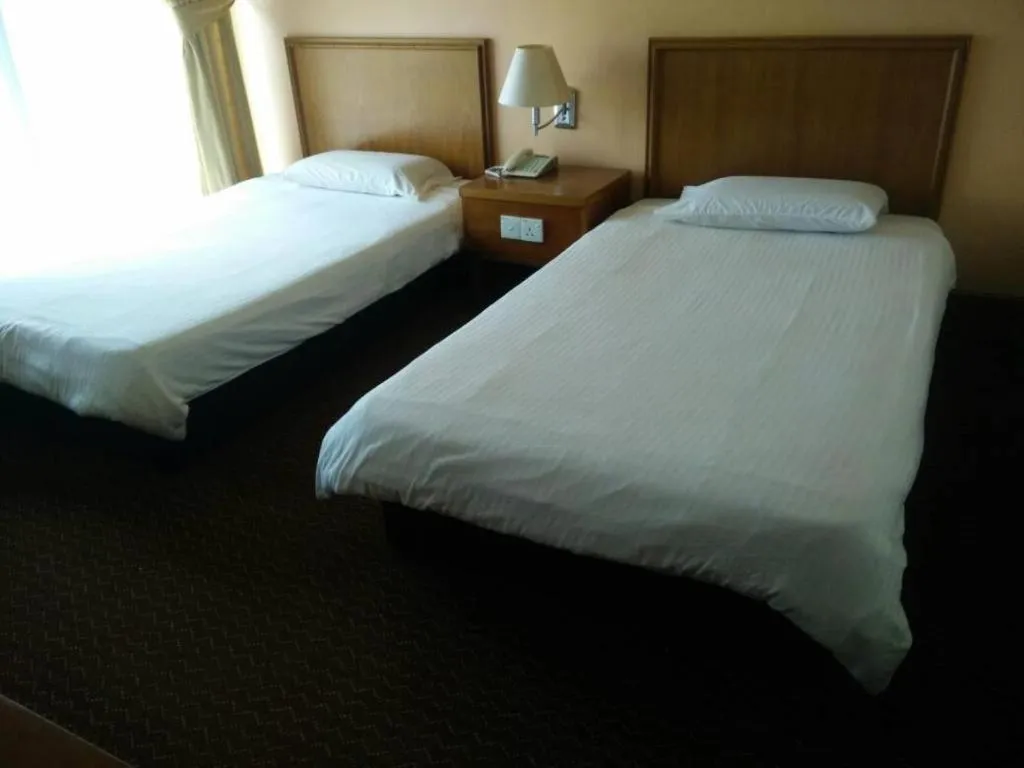Bed in Putra Brasmana Hotel