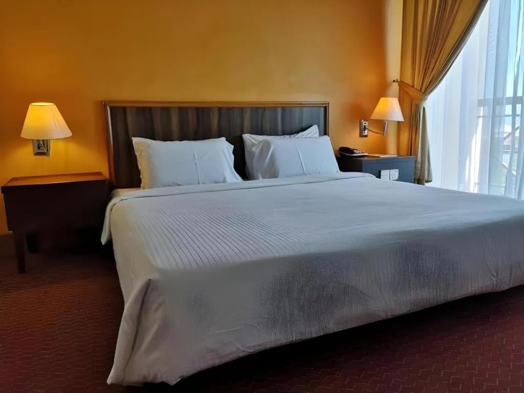 Bed in Putra Brasmana Hotel