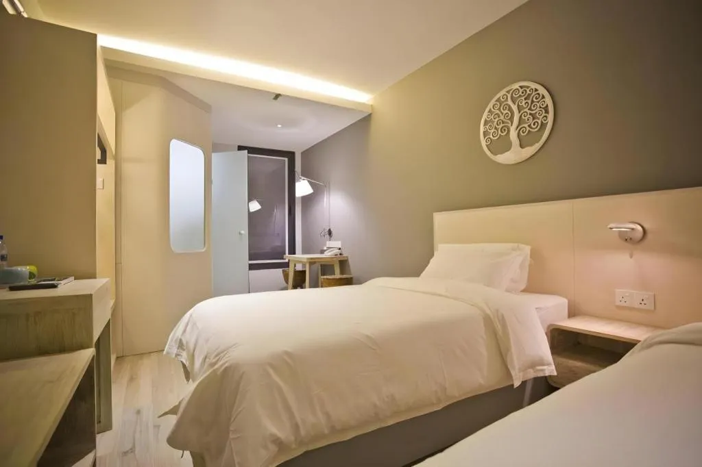 Bed in M Plus Boutique Hotel