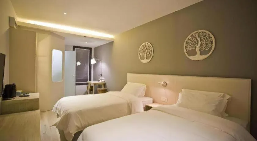 Bed in M Plus Boutique Hotel