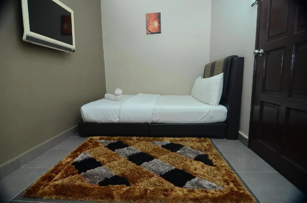 Bed in AMT BUDGET HOTEL