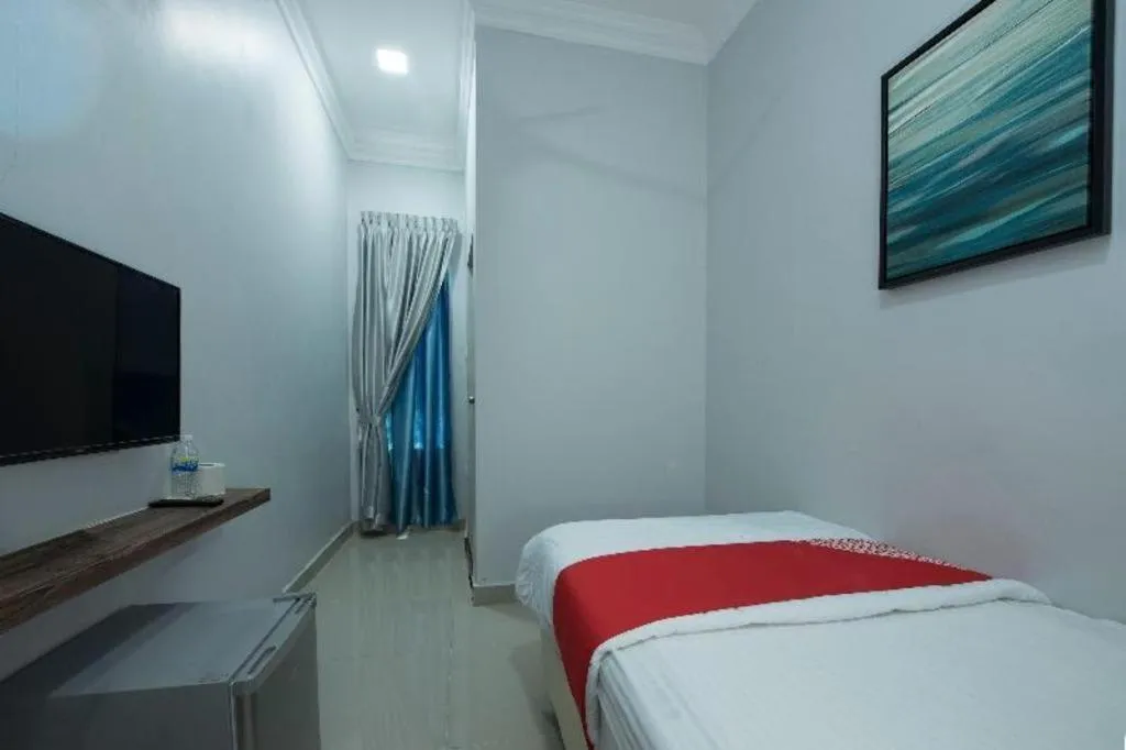 Bed in OYO 90234 Sungai Rengit City Resort 2