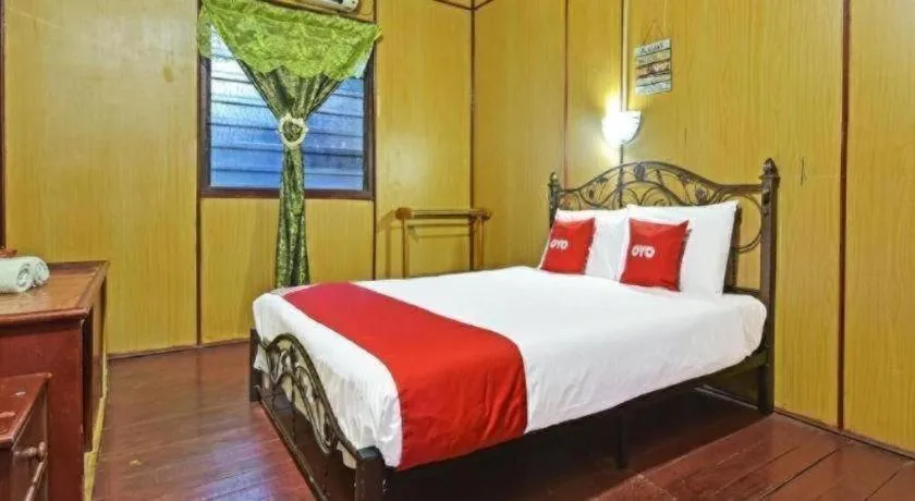 Bed in OYO 90620 Mahseer Chalet