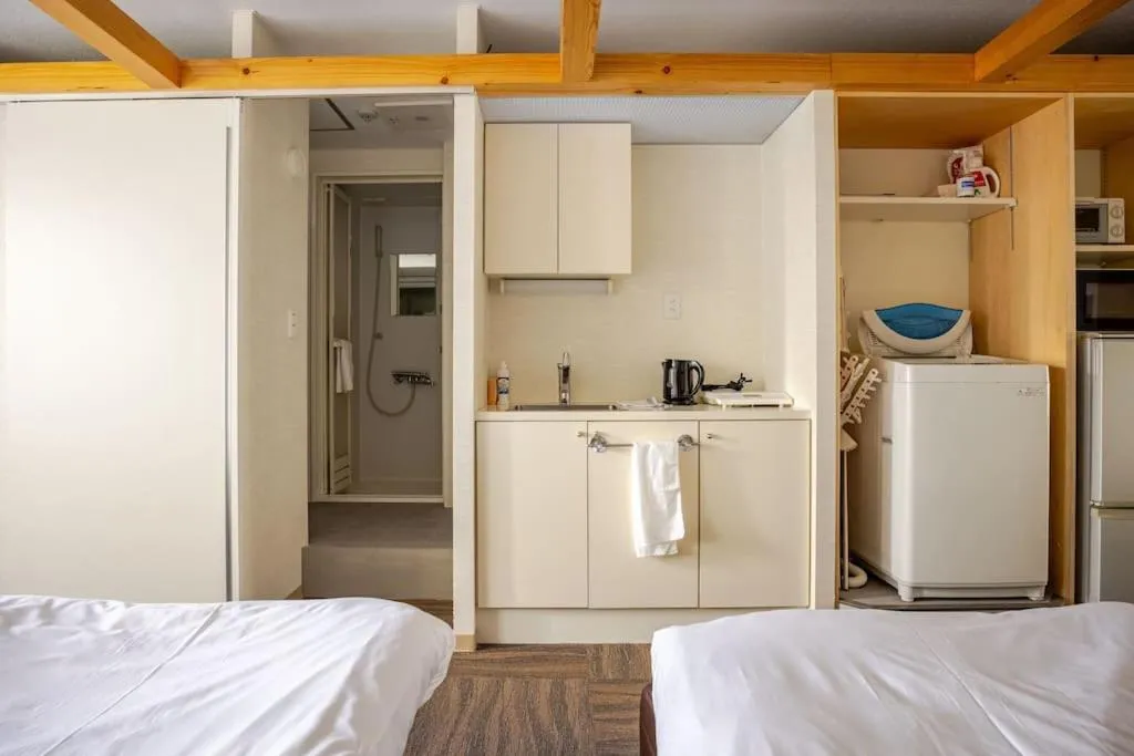 Kitchen or kitchenette, Bed in Fun Hotel Sapporo