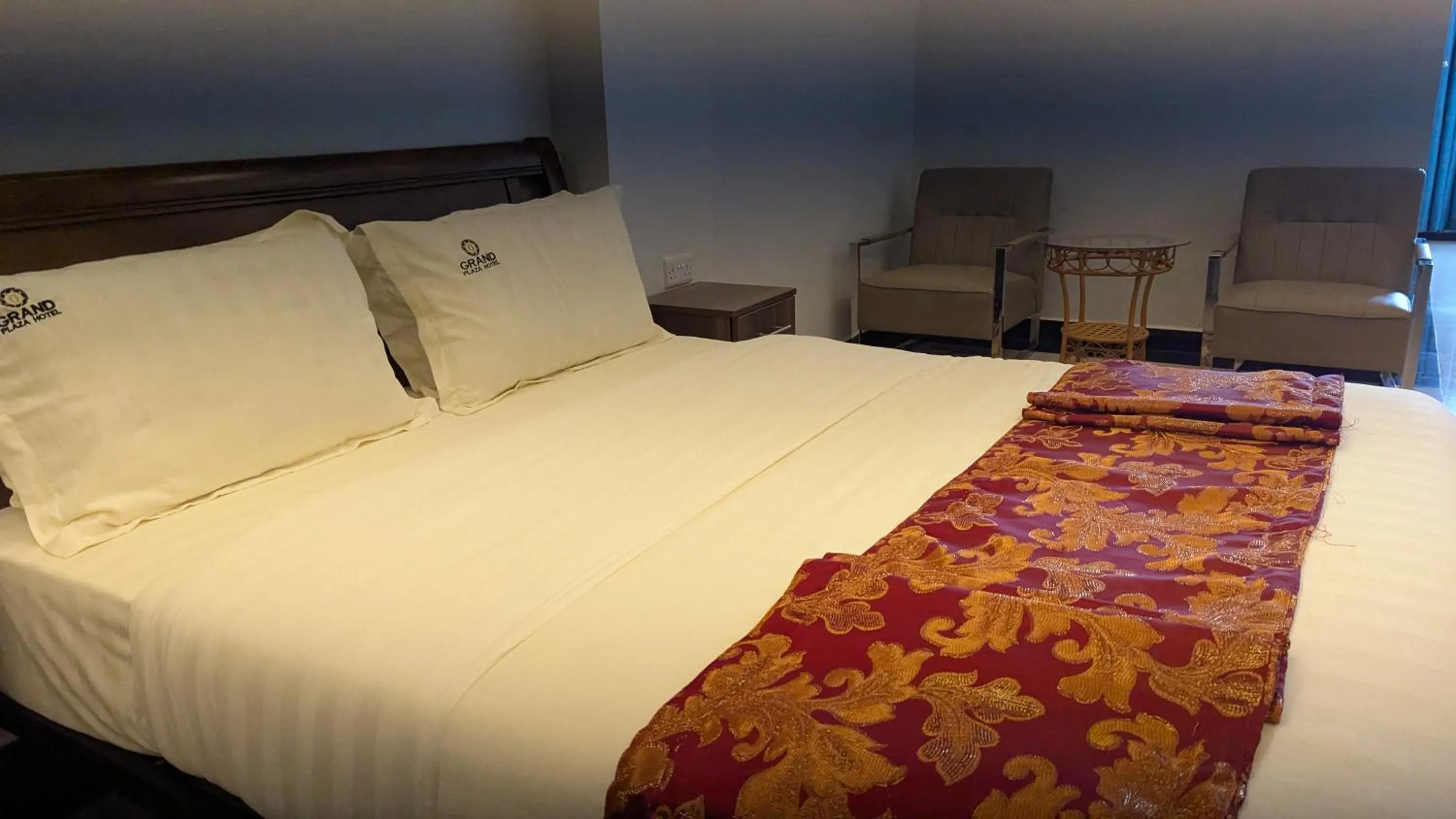 Photo of the whole room, Bed in The Grand Plaza Hotel