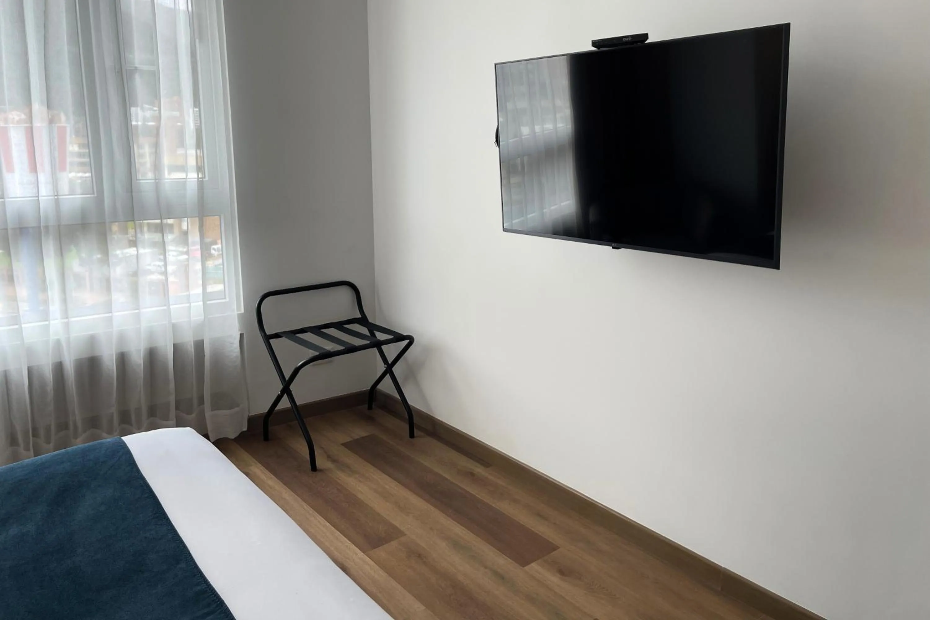 TV and multimedia, Bed in VOU Suites by Avia Suites