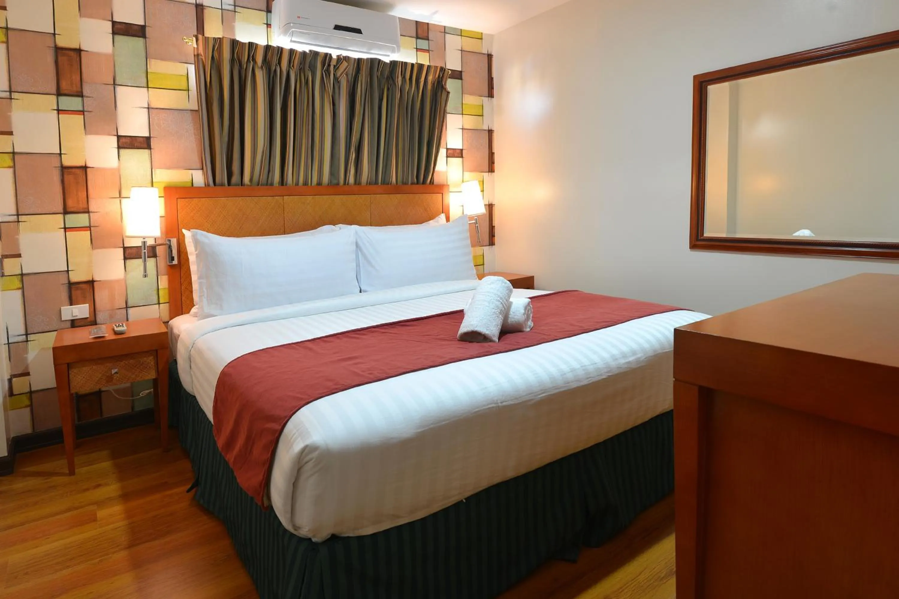 Bed in Royal Suites Condotel