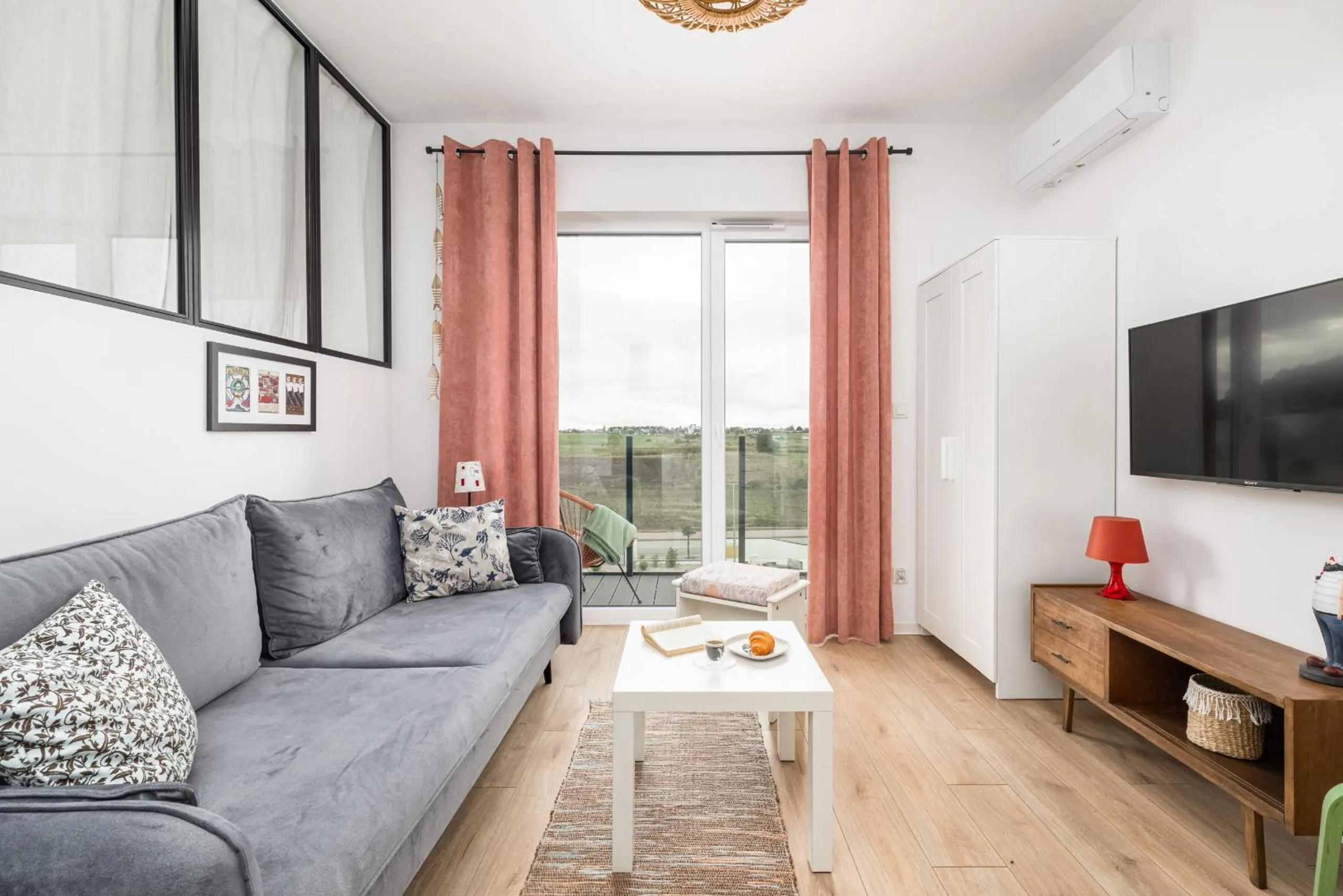 Seating area in Szprotka Apartment with Air-Conditioning & Parking by Noclegi Renters