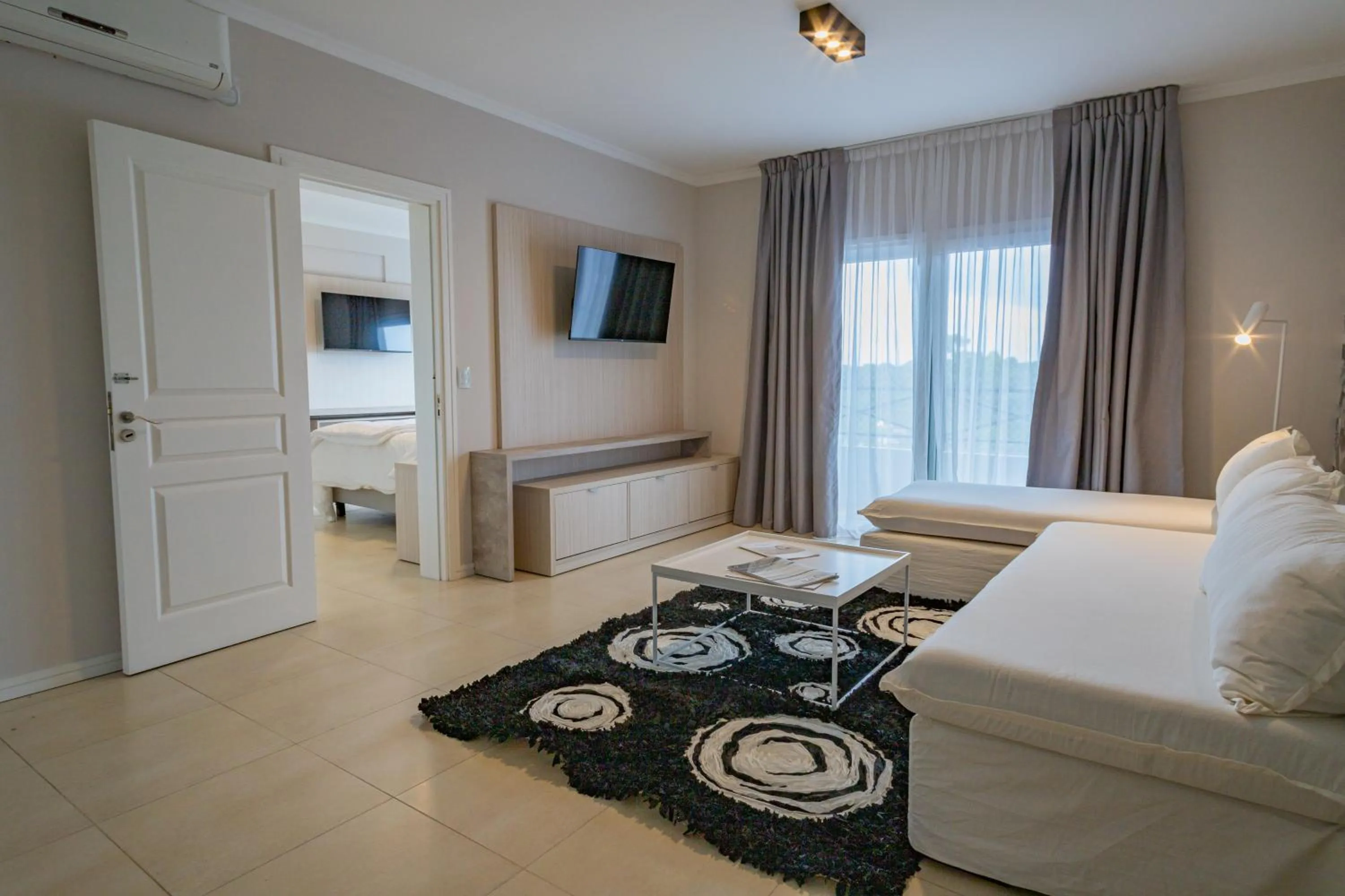 Living room, Bed in Garden Suites Pinamar
