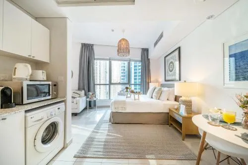 Kitchen or kitchenette, Bed in Airstay - Chic Studio - Marina View - Dubai Marina - Monthly Offer Available