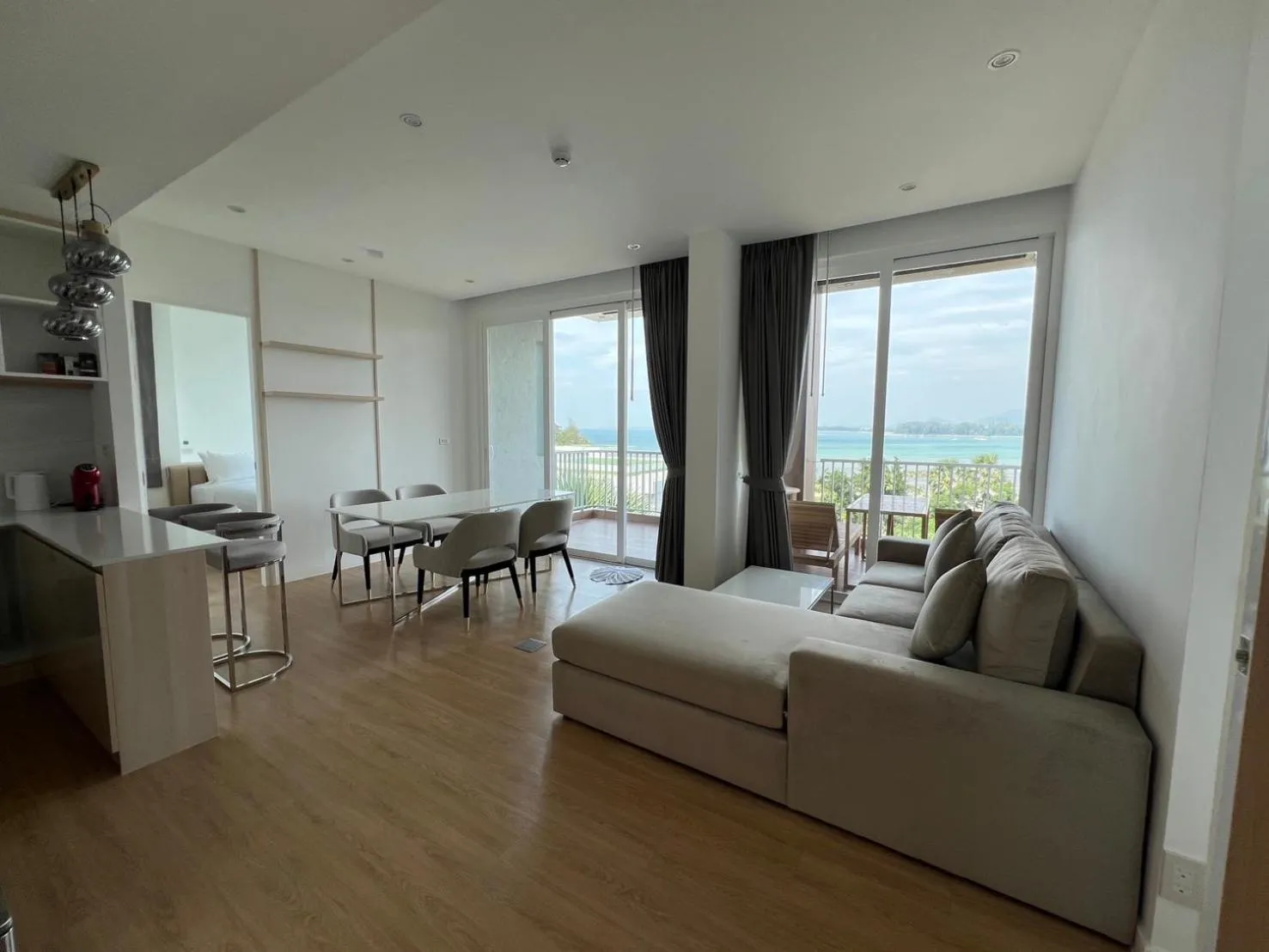 Seating area in Beachfront Bliss at Naiyang Phuket by ALPHATEL