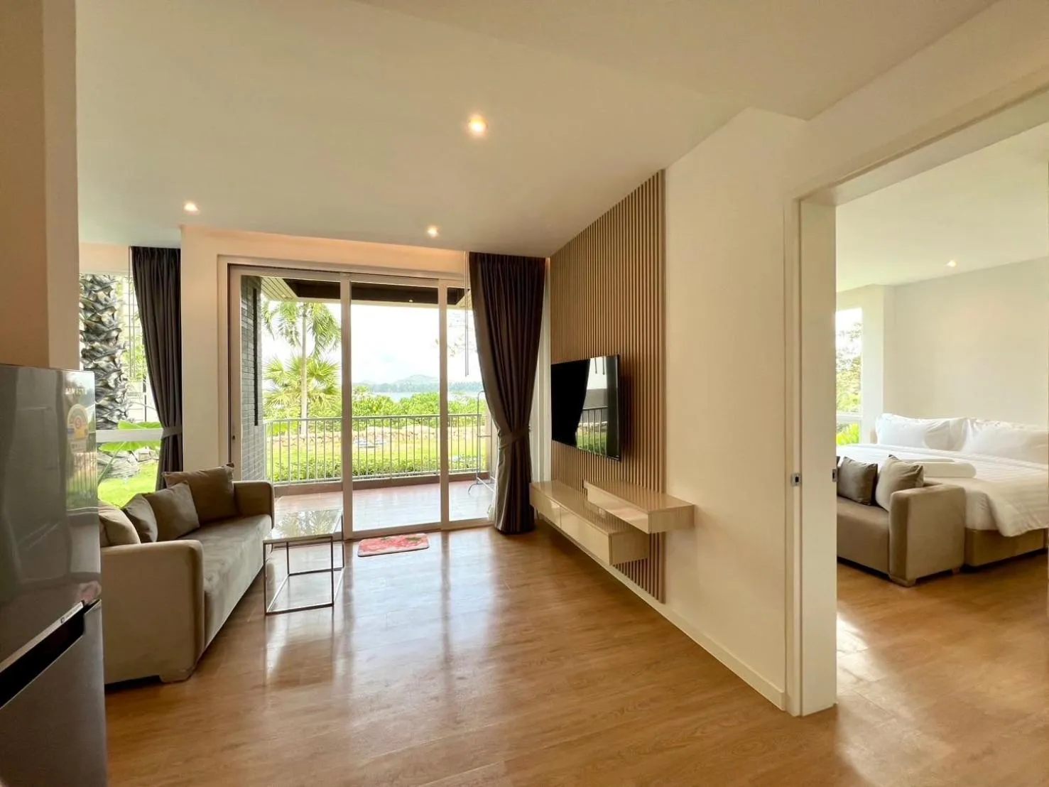 Living room, Bed in Beachfront Bliss at Naiyang Phuket by ALPHATEL