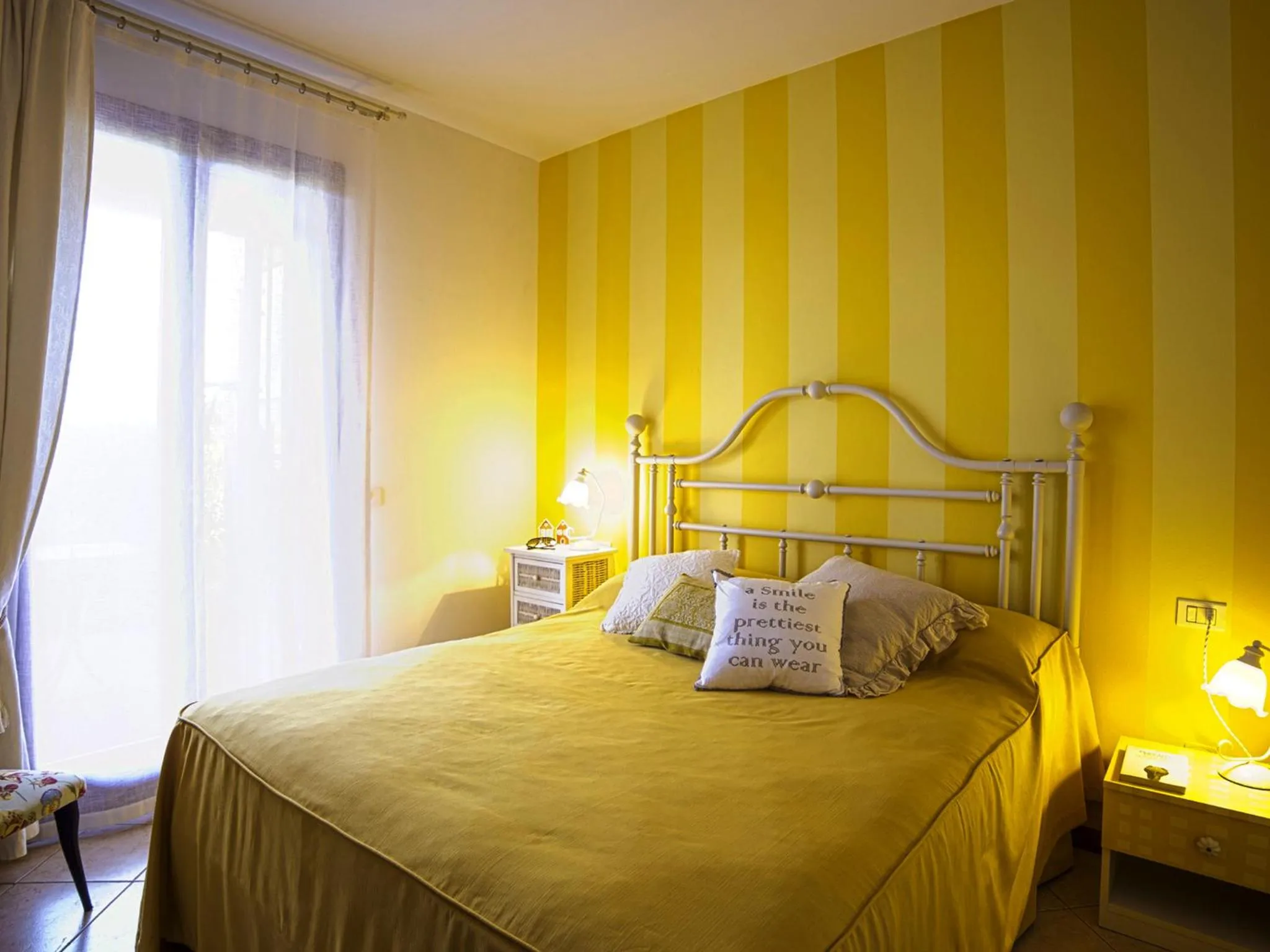 Bed in BellaSirmione Holiday Apartments