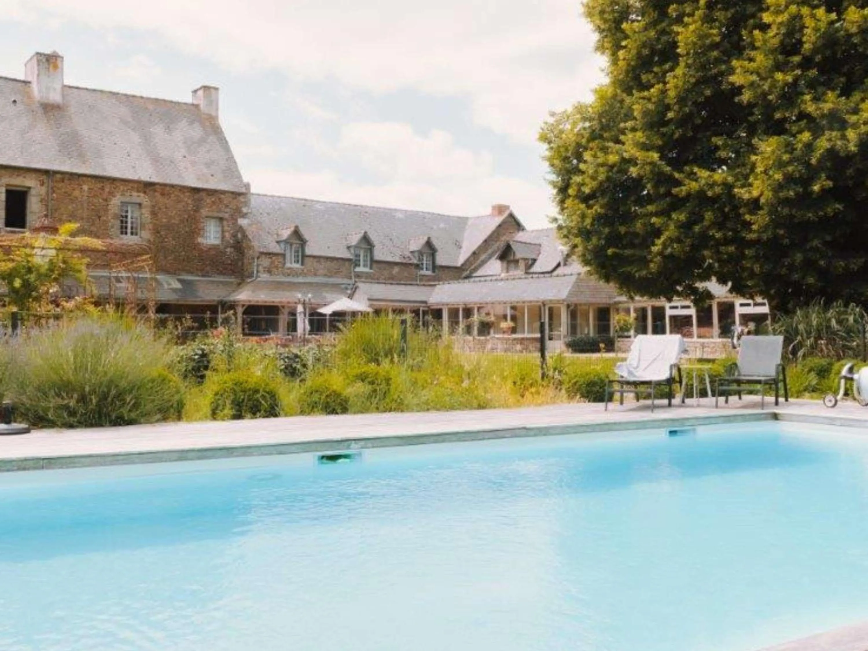 Pool view in Hotel de L'Abbaye Le Tronchet - Handwritten Collection