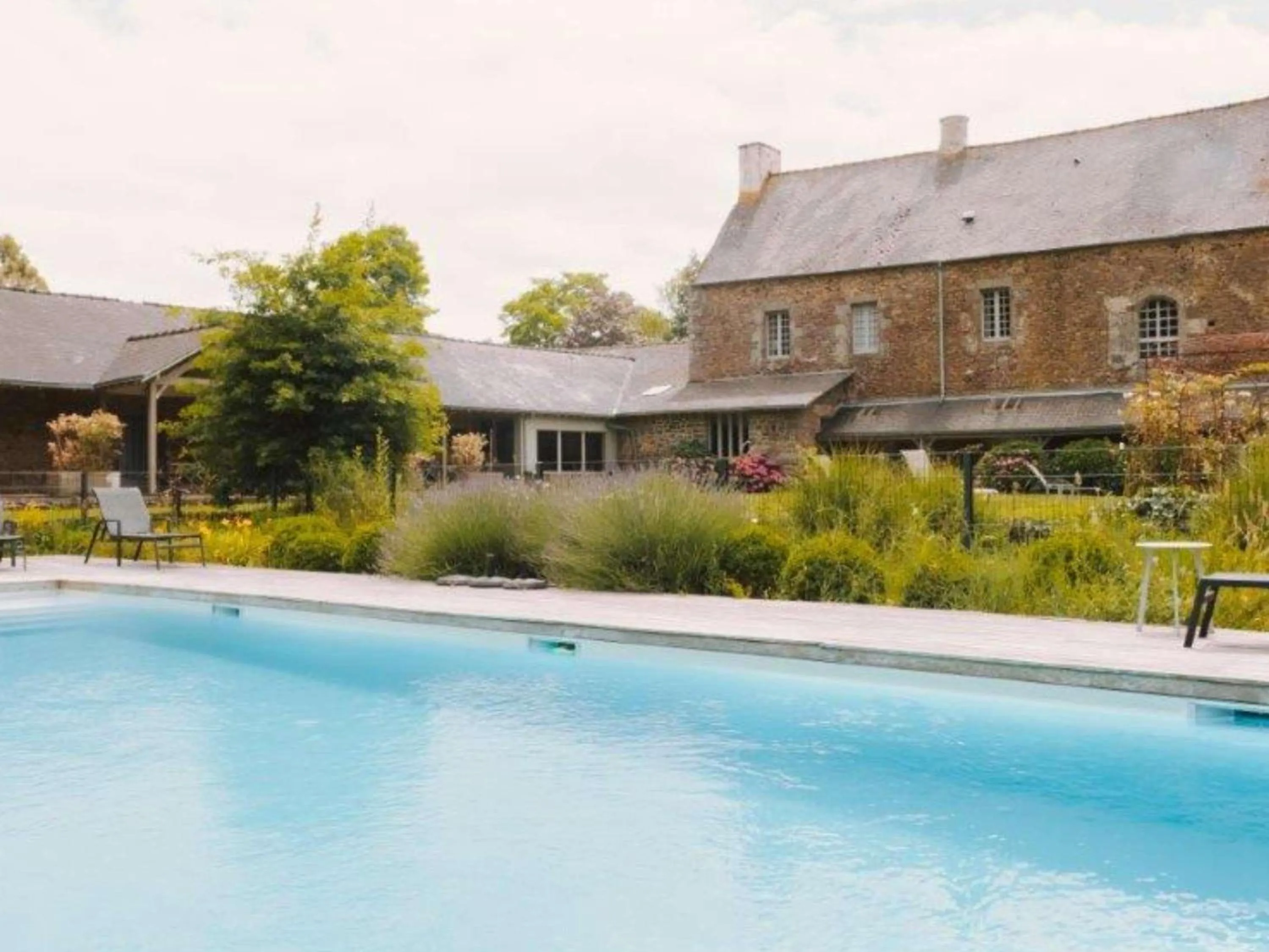 Pool view in Hotel de L'Abbaye Le Tronchet - Handwritten Collection