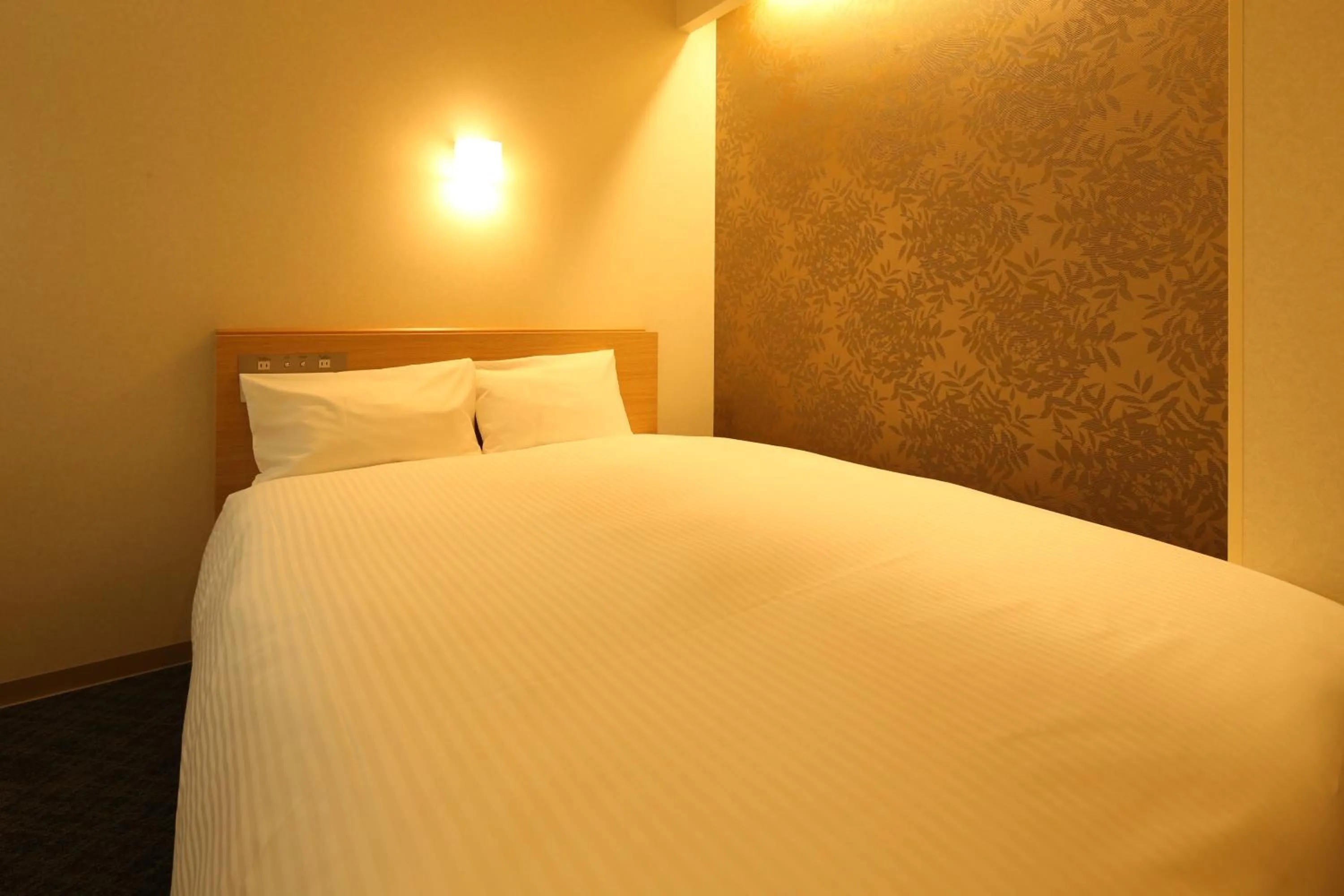 Bed in AB Hotel Sakaihigashi