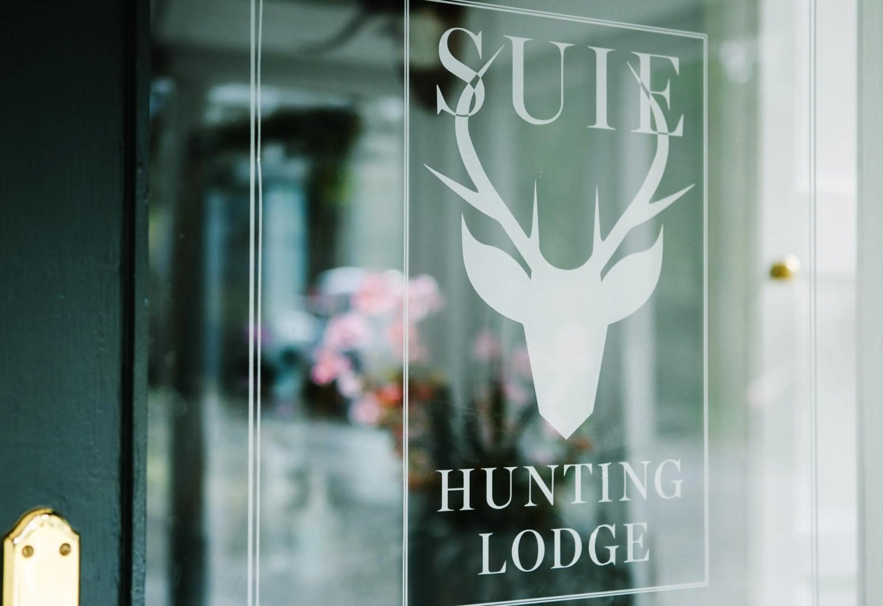Property logo or sign in Suie Hunting Lodge