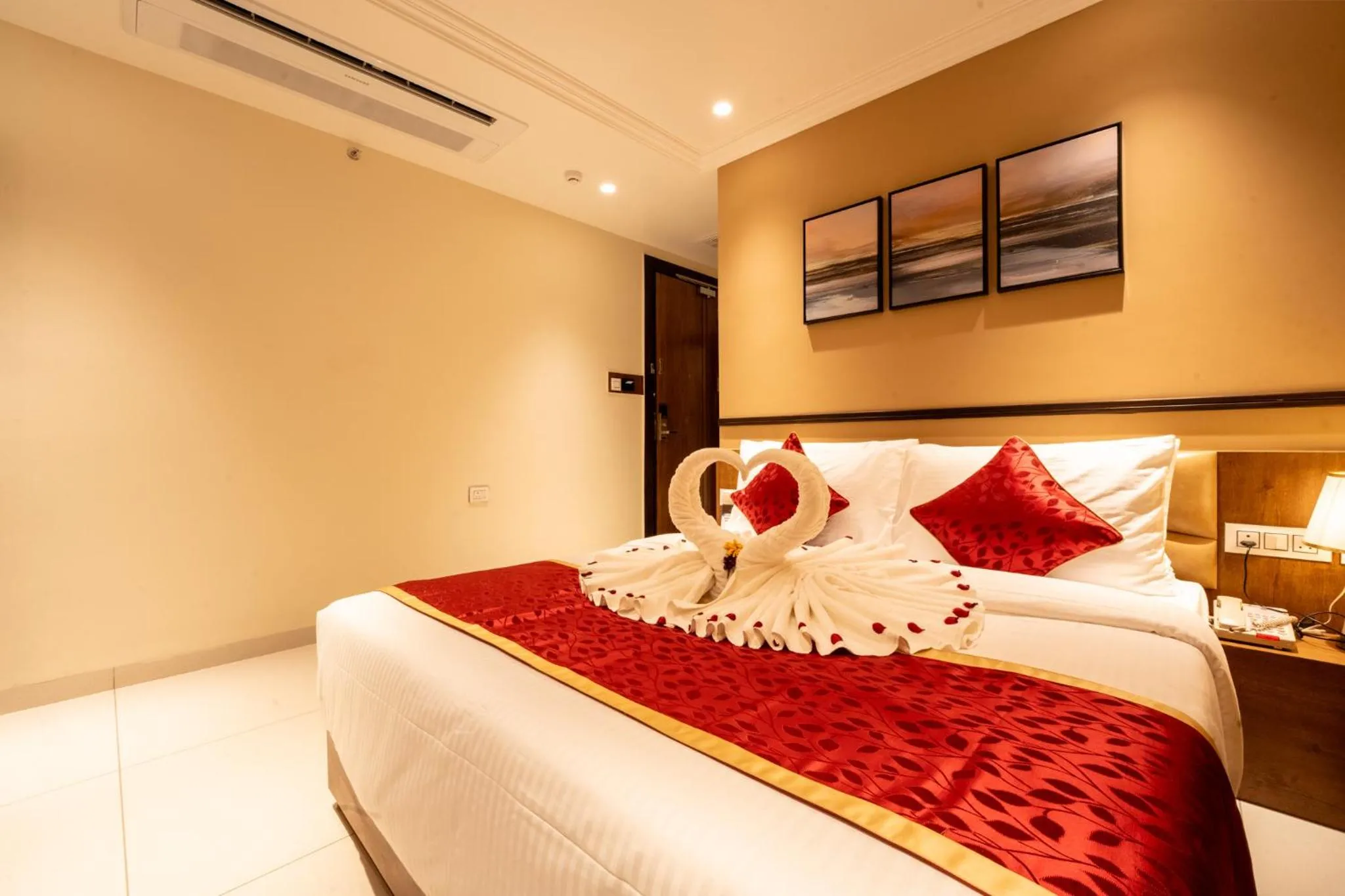 Bed in Ramee Tarang Hotel Indore