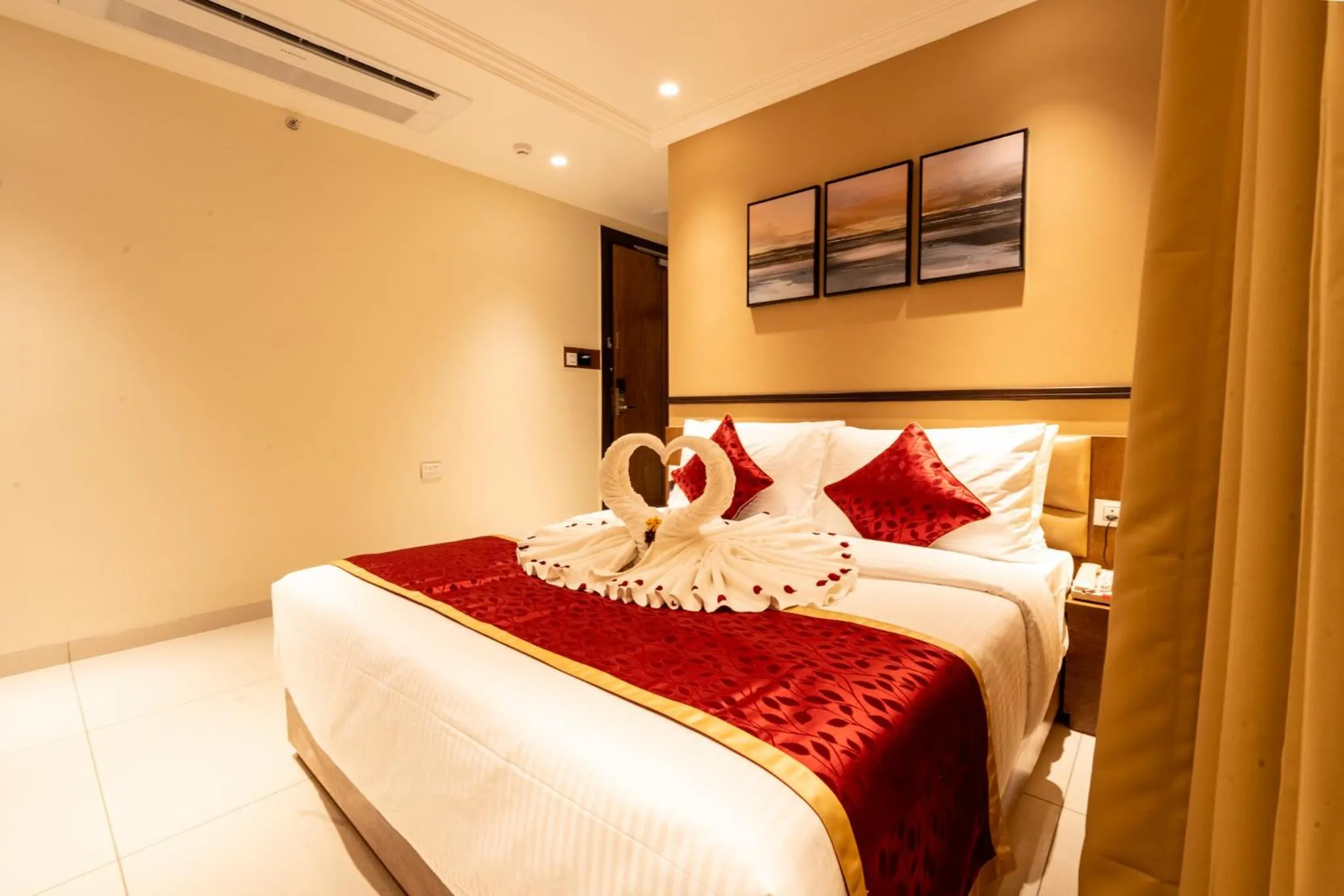 Bed in Ramee Tarang Hotel Indore