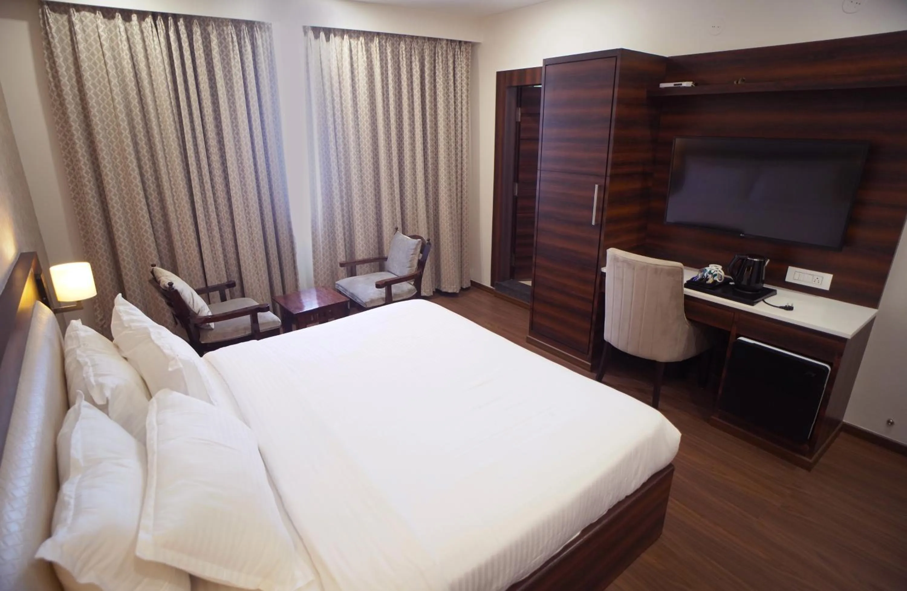 Photo of the whole room, Bed in Sai Maa Hotel & Residency