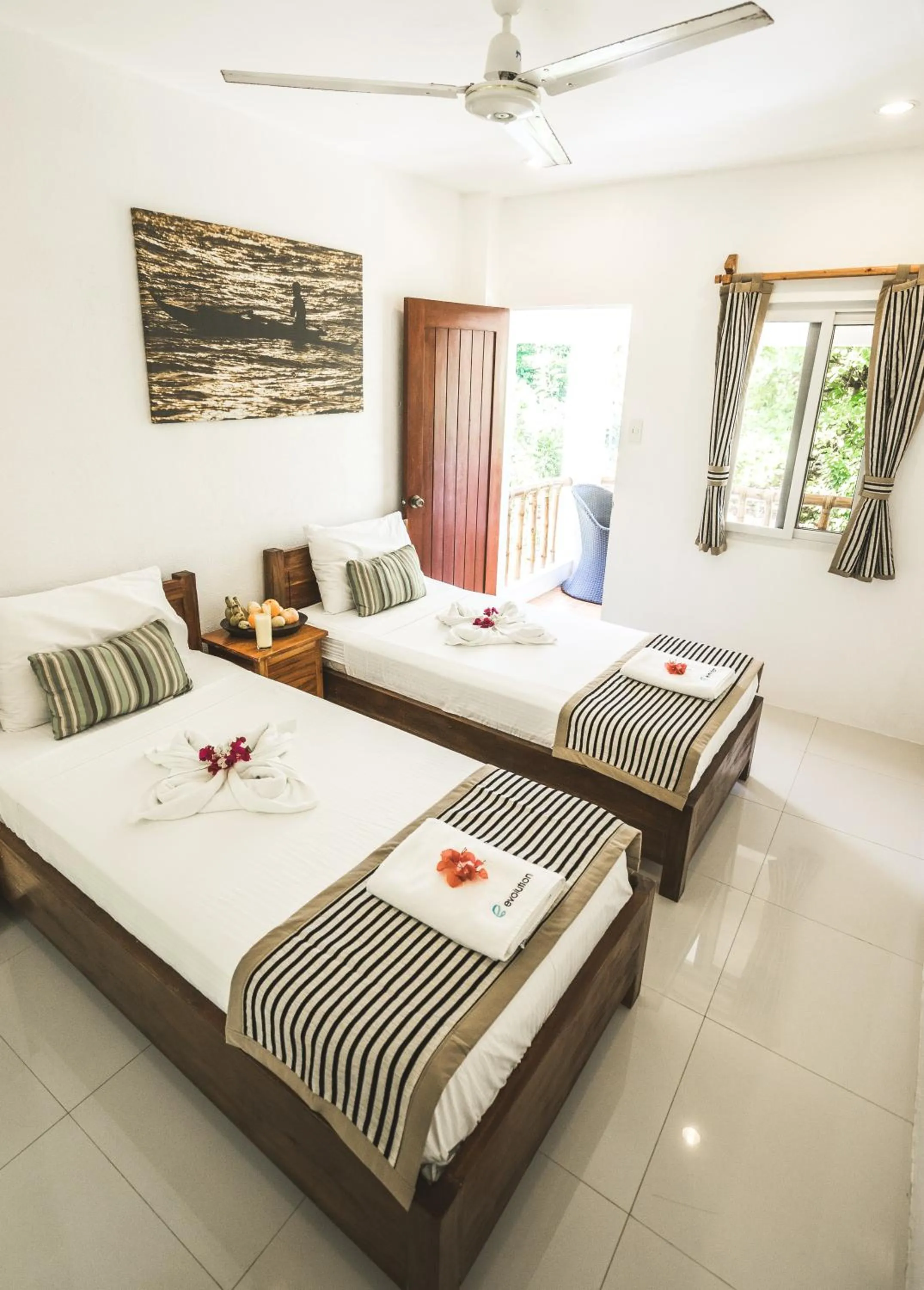 Photo of the whole room, Bed in Evolution Dive and Beach Resort