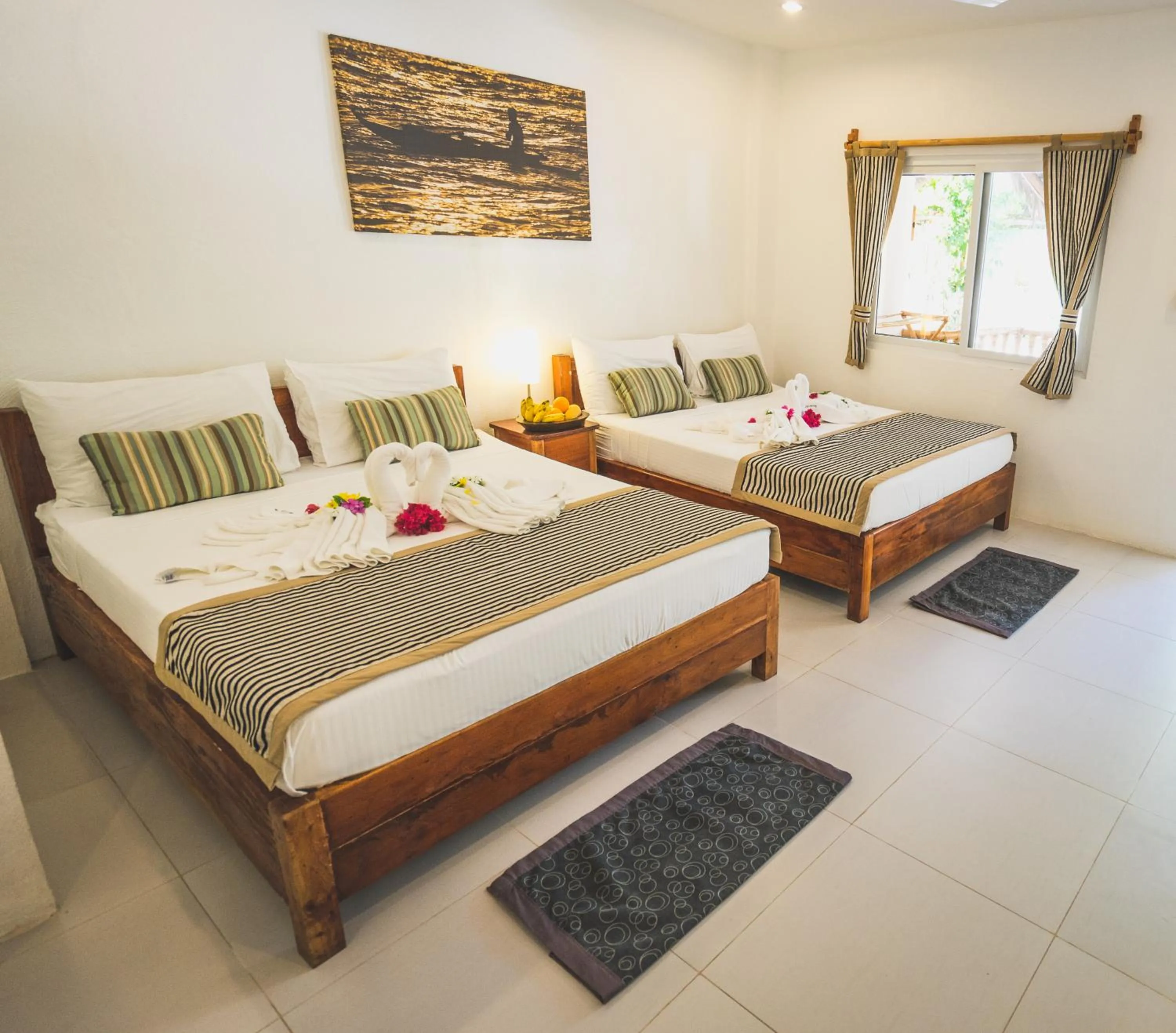 Photo of the whole room, Bed in Evolution Dive and Beach Resort