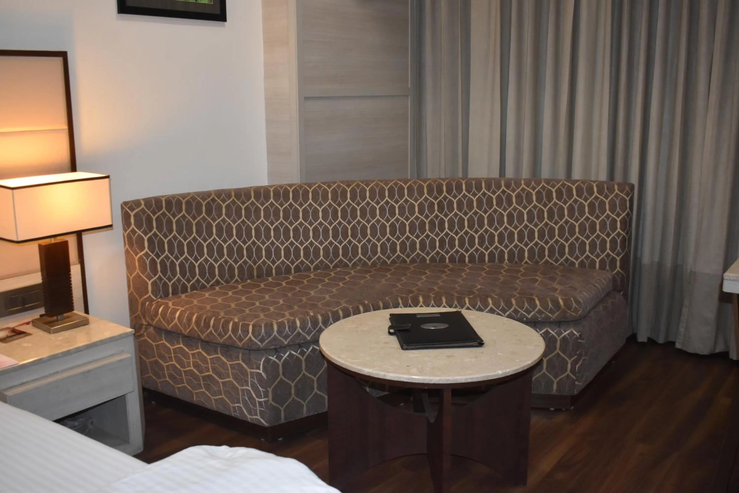 Seating area, Bed in Chanakya Hotel, Patna
