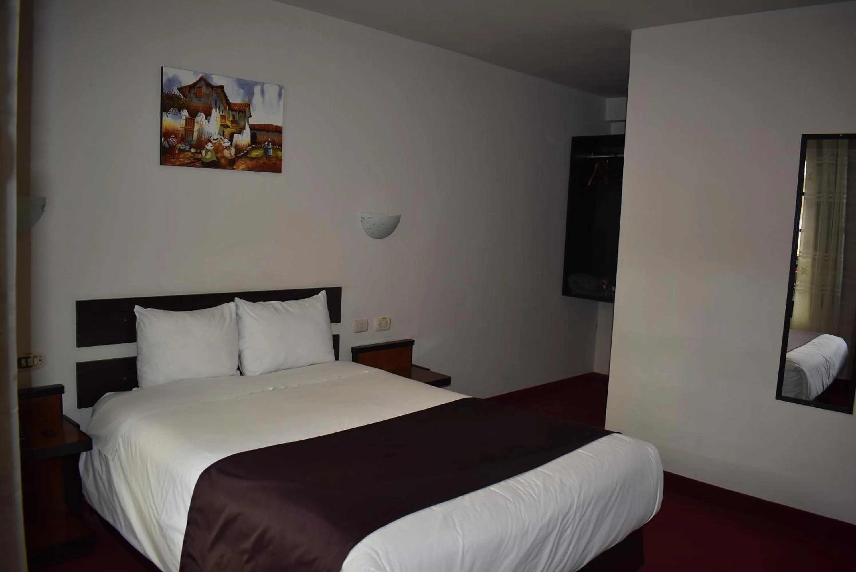 Bed in Colonial Plaza Hotel