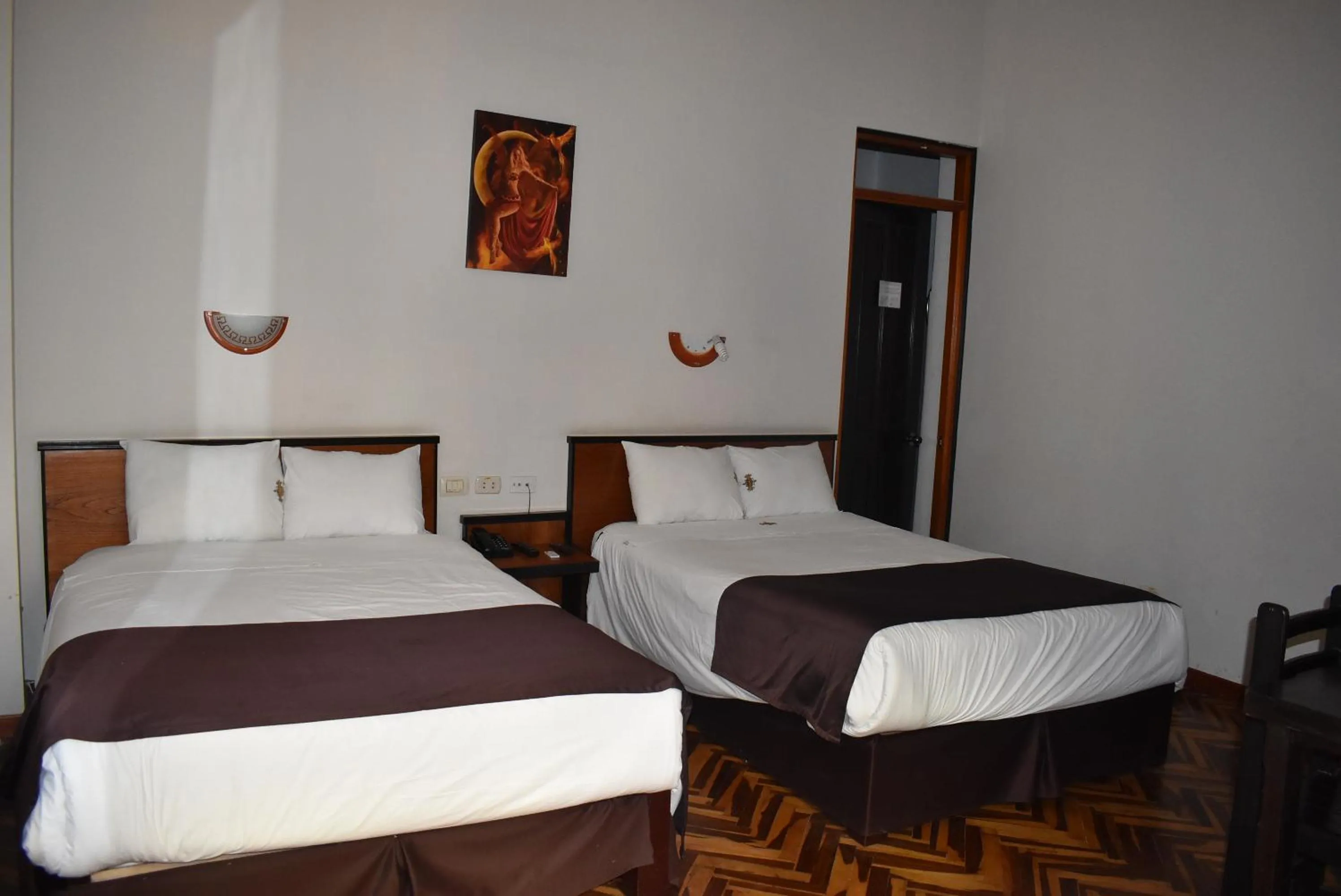 Bed in Colonial Plaza Hotel