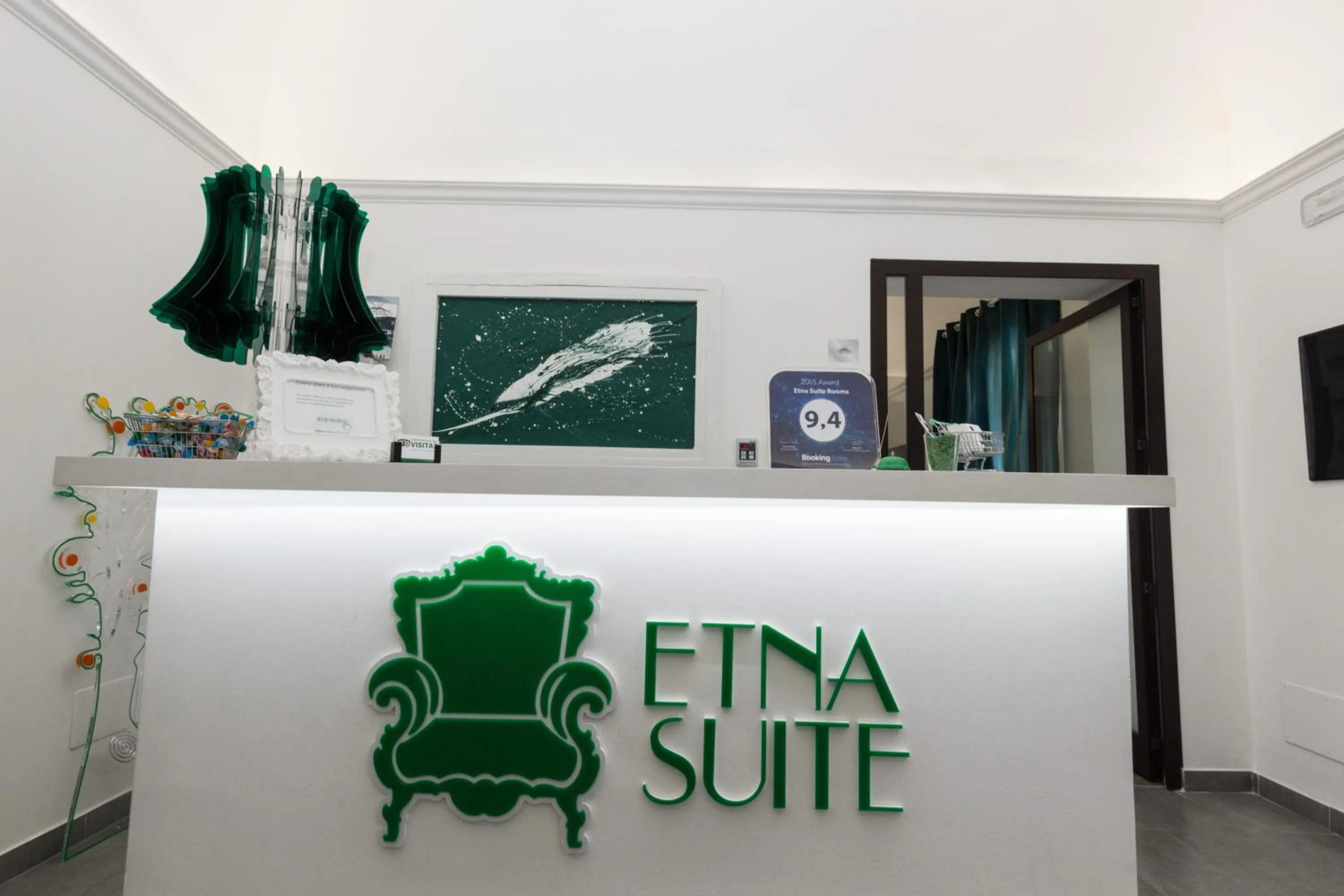 Property logo or sign in Etna Suite Group