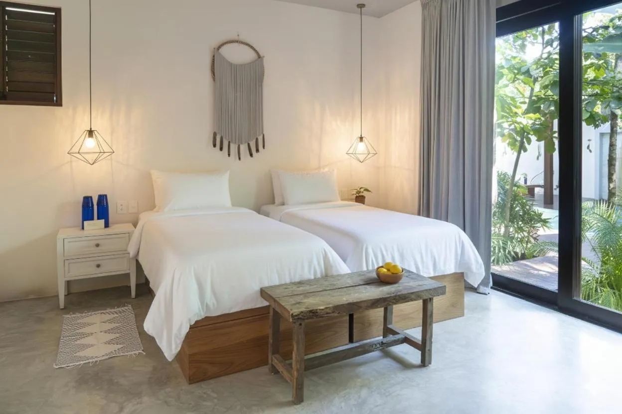 Bed in La Zebra Tulum, a Small Luxury Hotel