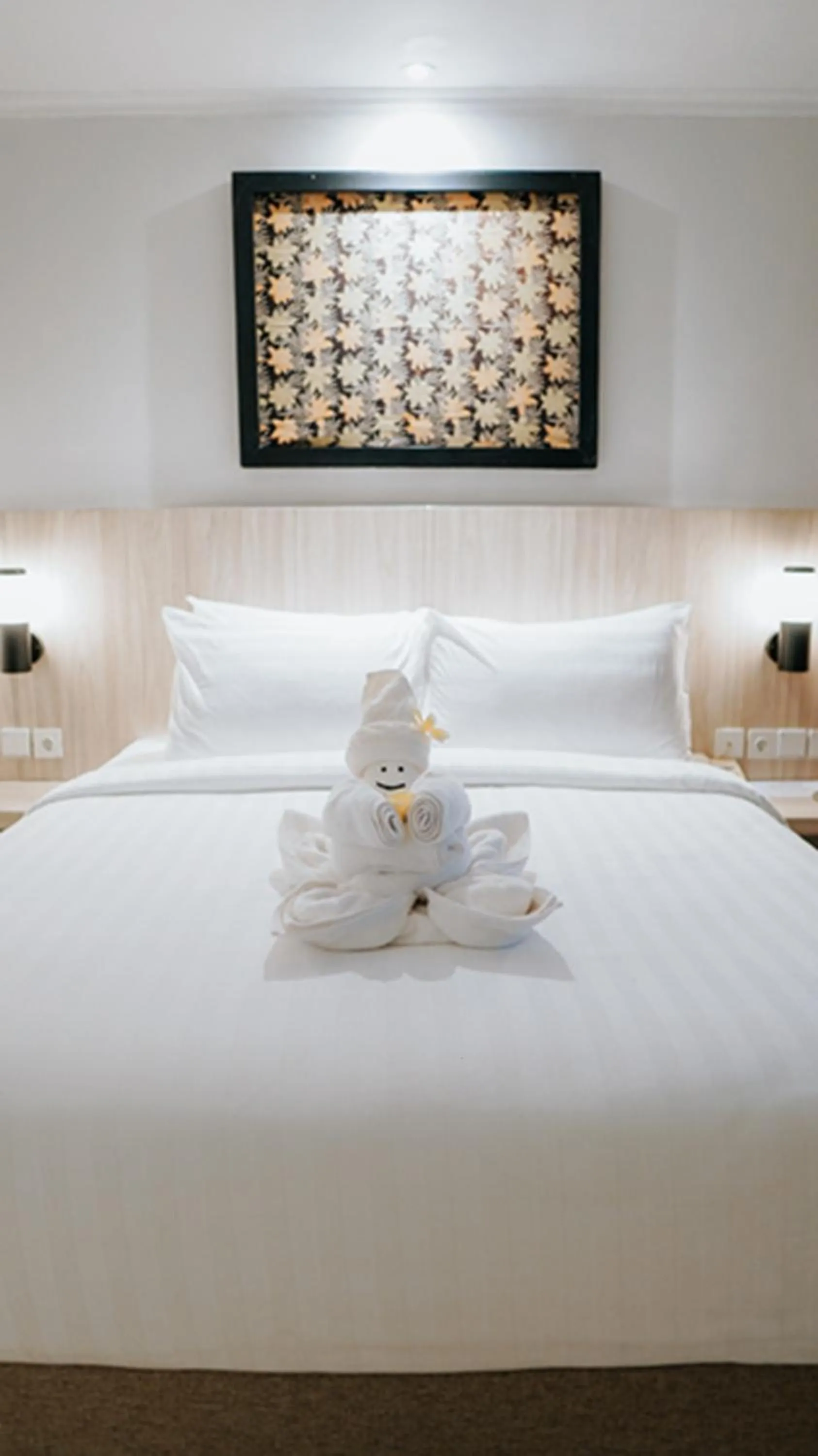 Bed in Tuwuh Hotel at Kayutangan