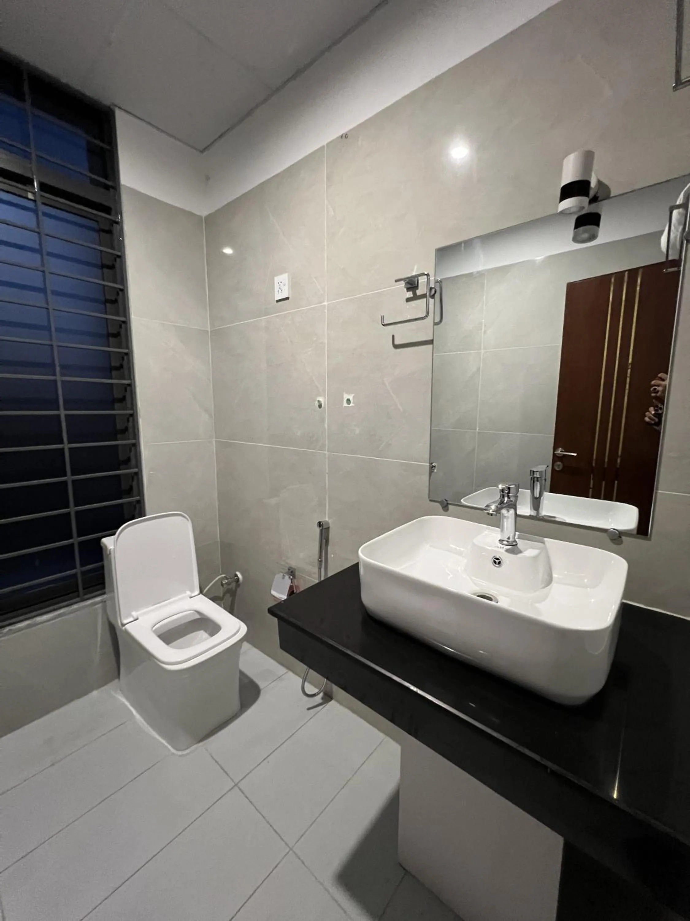 Toilet in Courteous Hotel