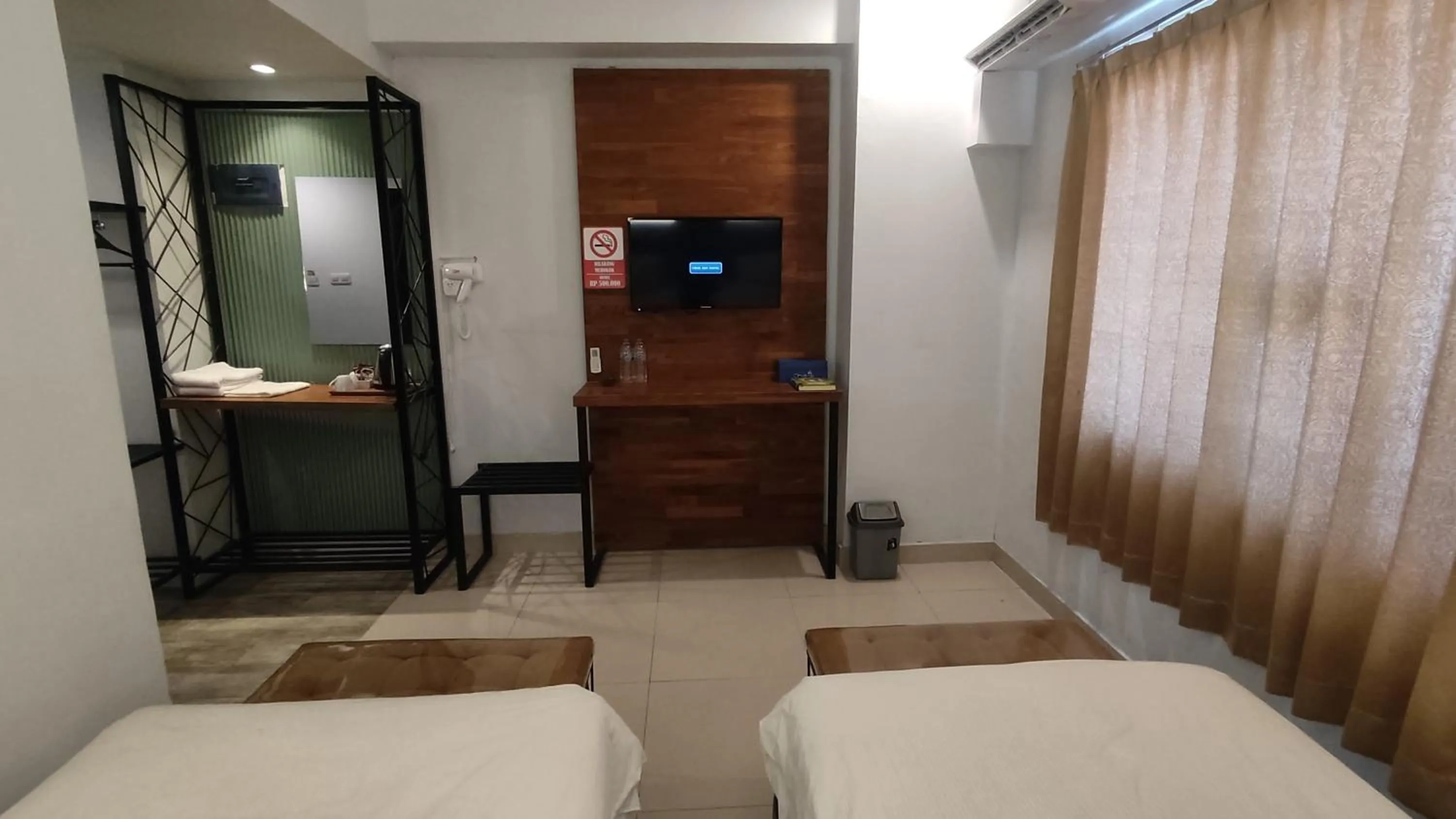 Bed in De La Charis Hotel by Waringin Hospitality