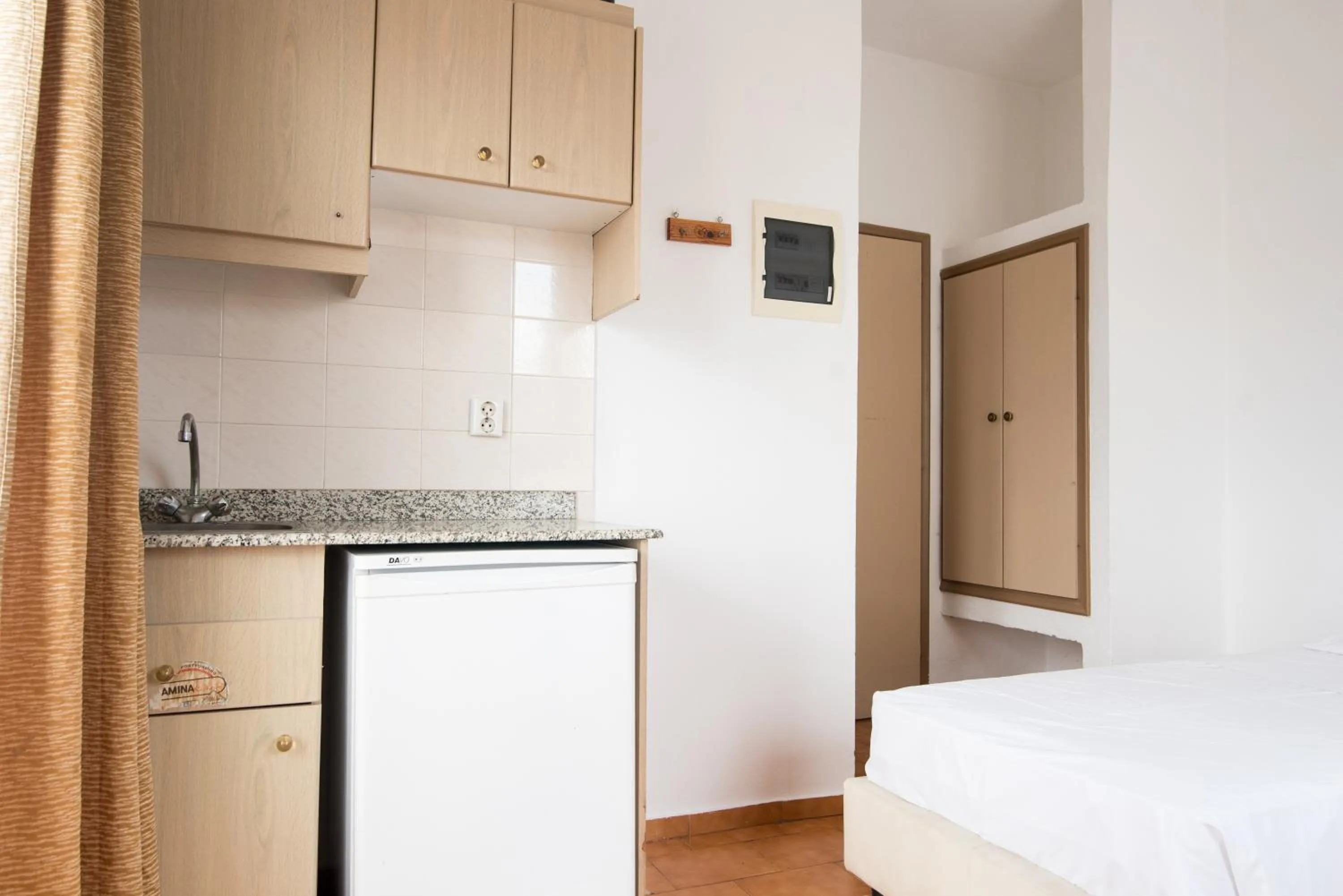 Kitchen or kitchenette, Bed in Ibiscus Hotel Malia