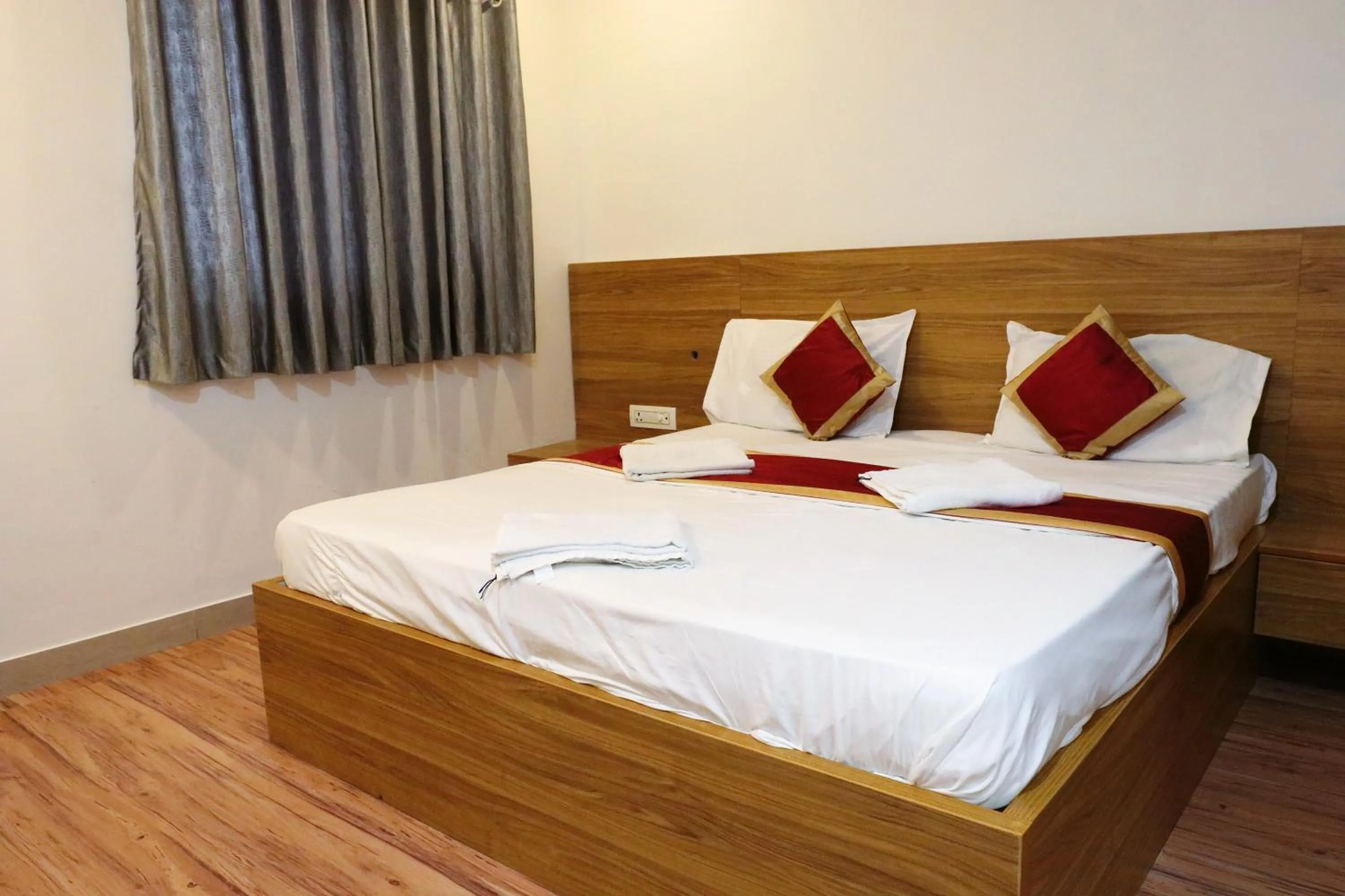 Bed in Sai Comforts Rooms