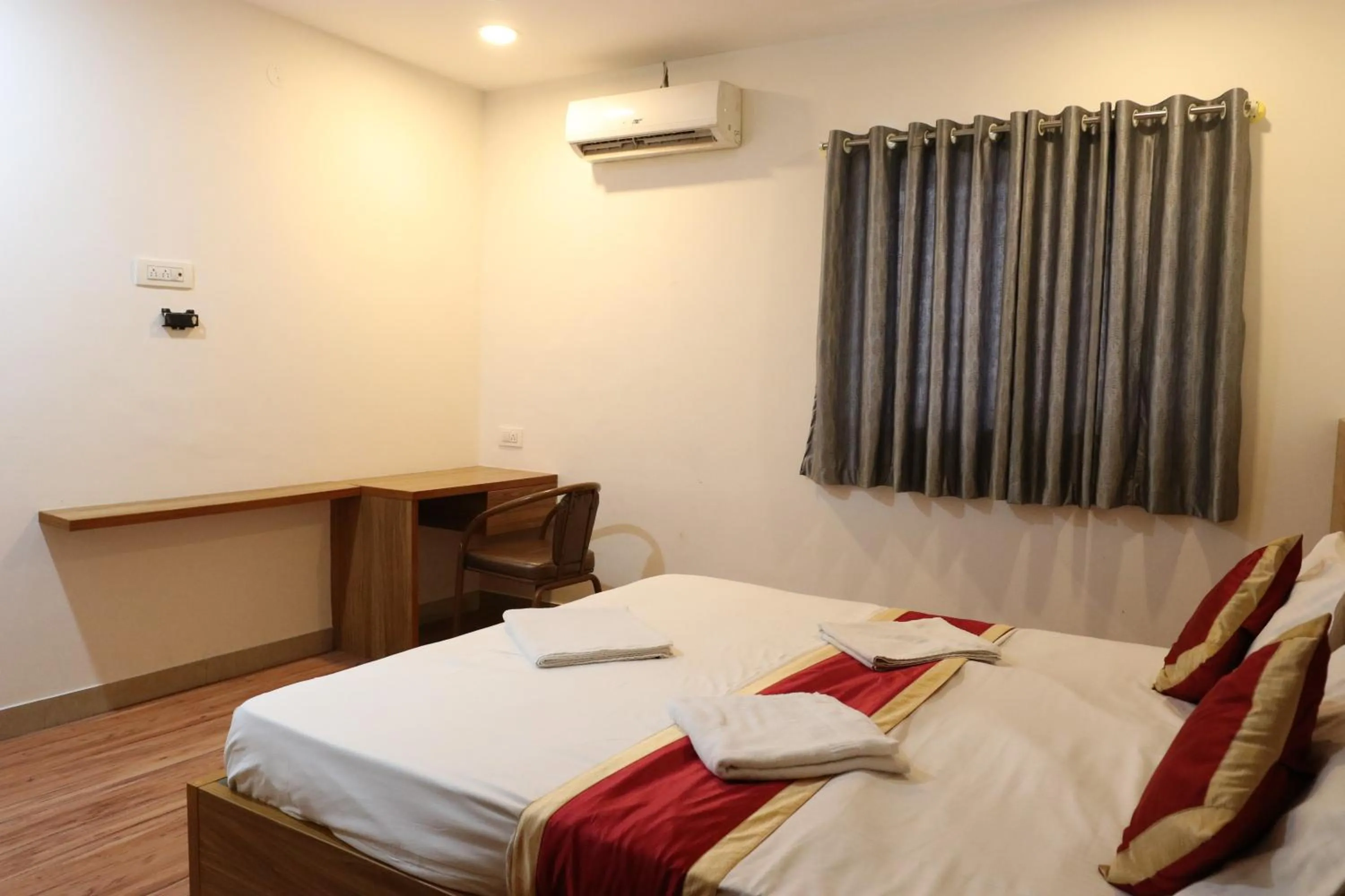 Bed in Sai Comforts Rooms