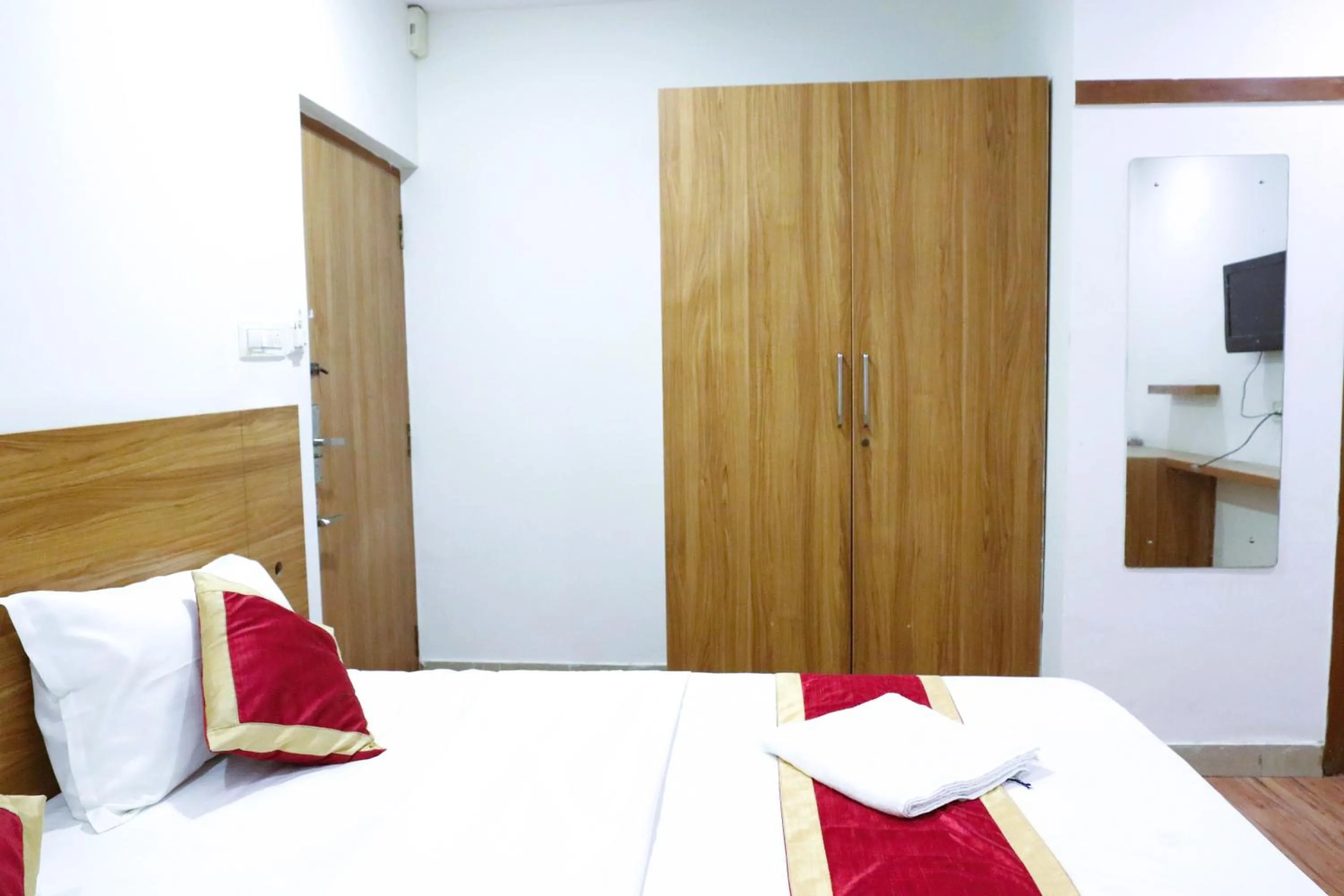 Bed in Sai Comforts Rooms