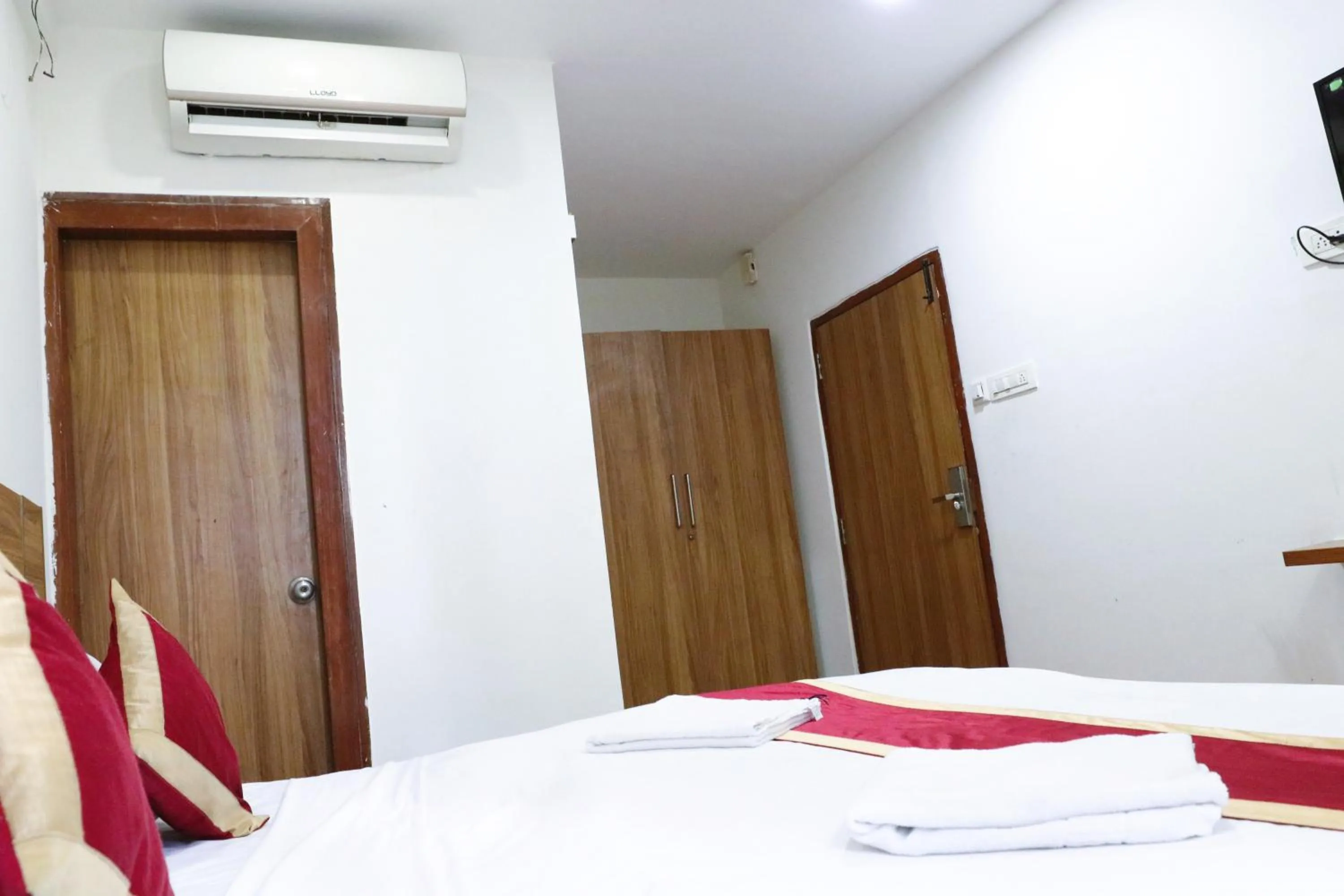 Bed in Sai Comforts Rooms