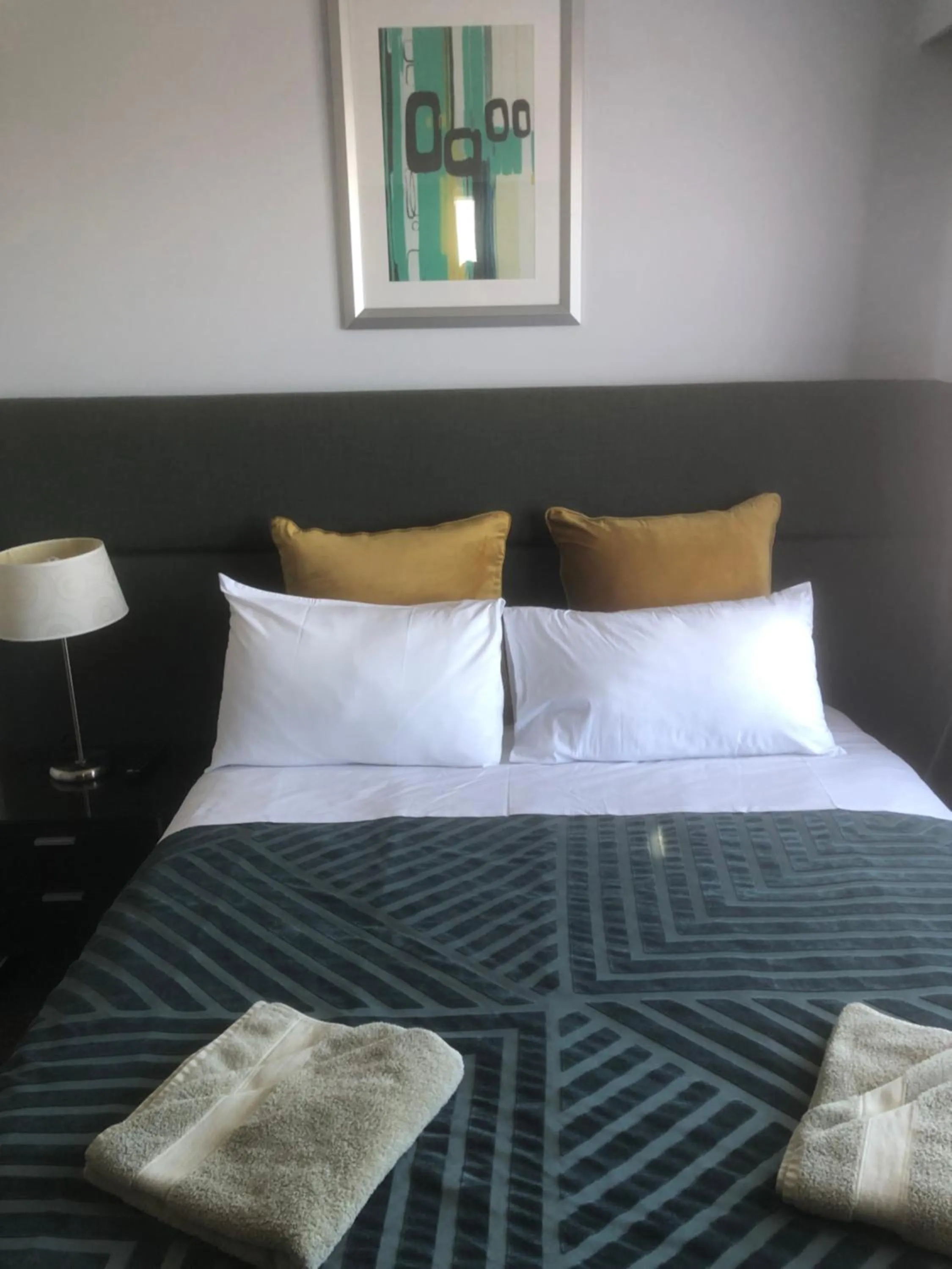 Bed in White Manor Motel