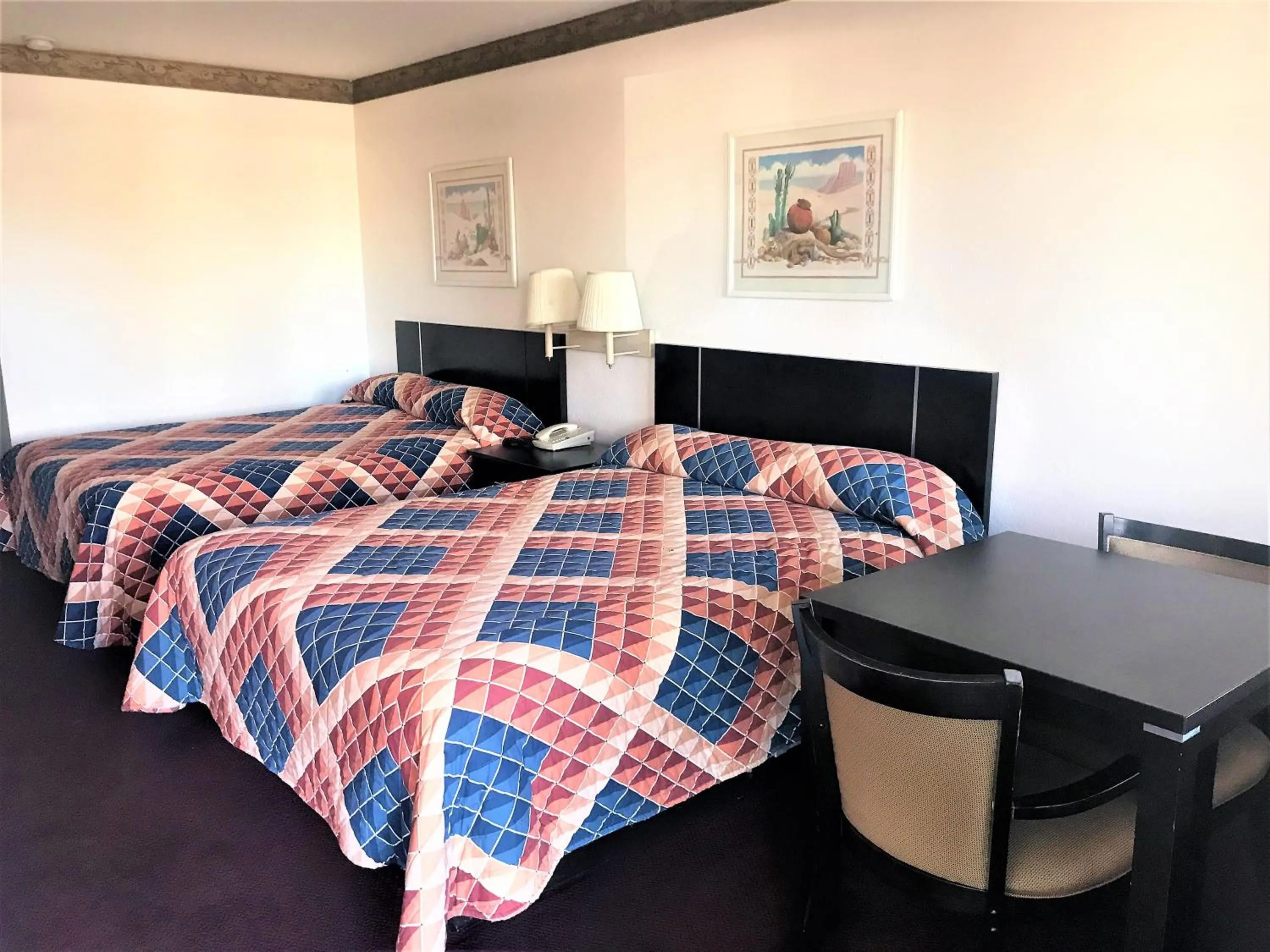 Bed in American Inn & Suites