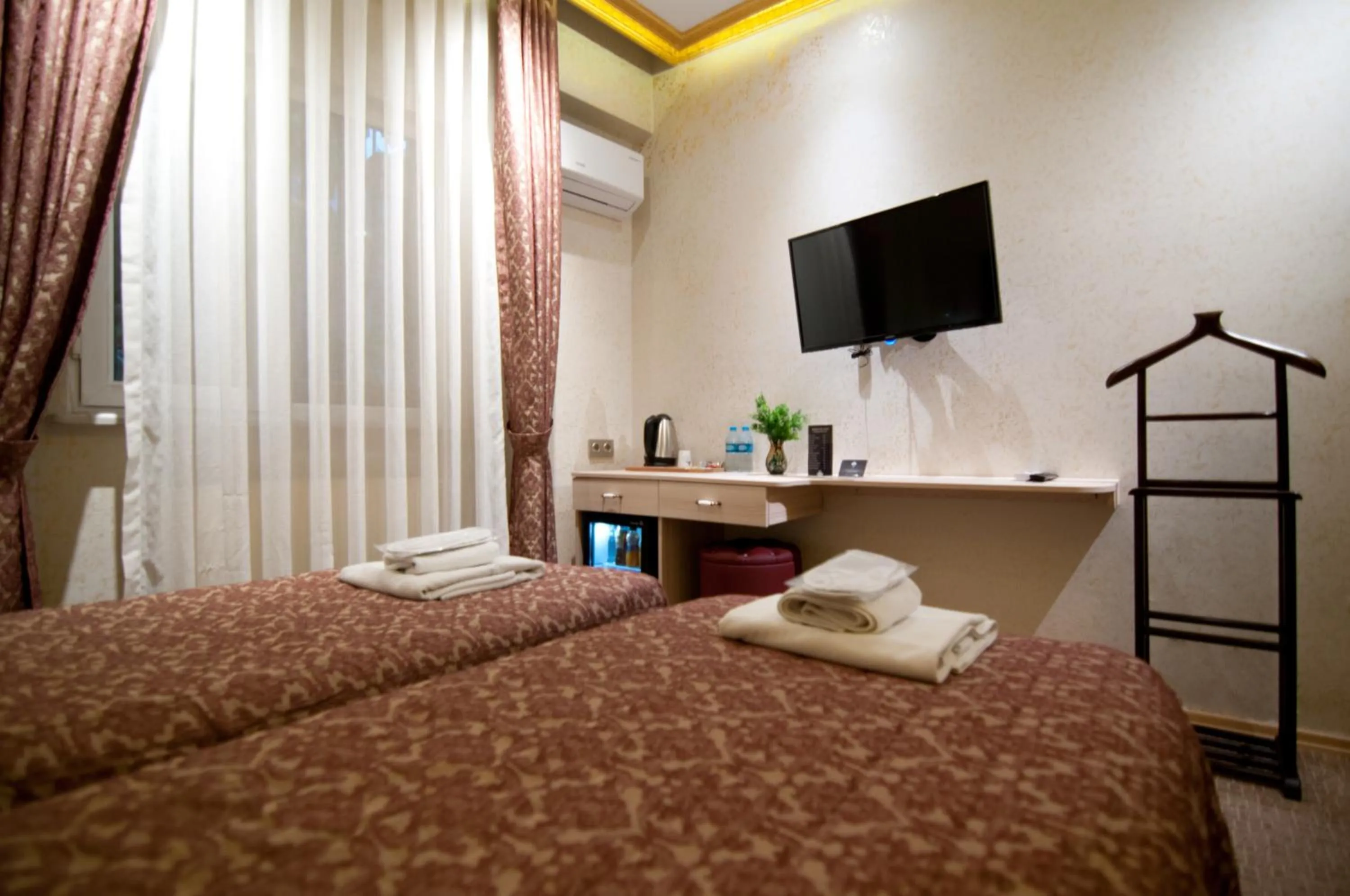 Bed in Grand Ambiance Hotel