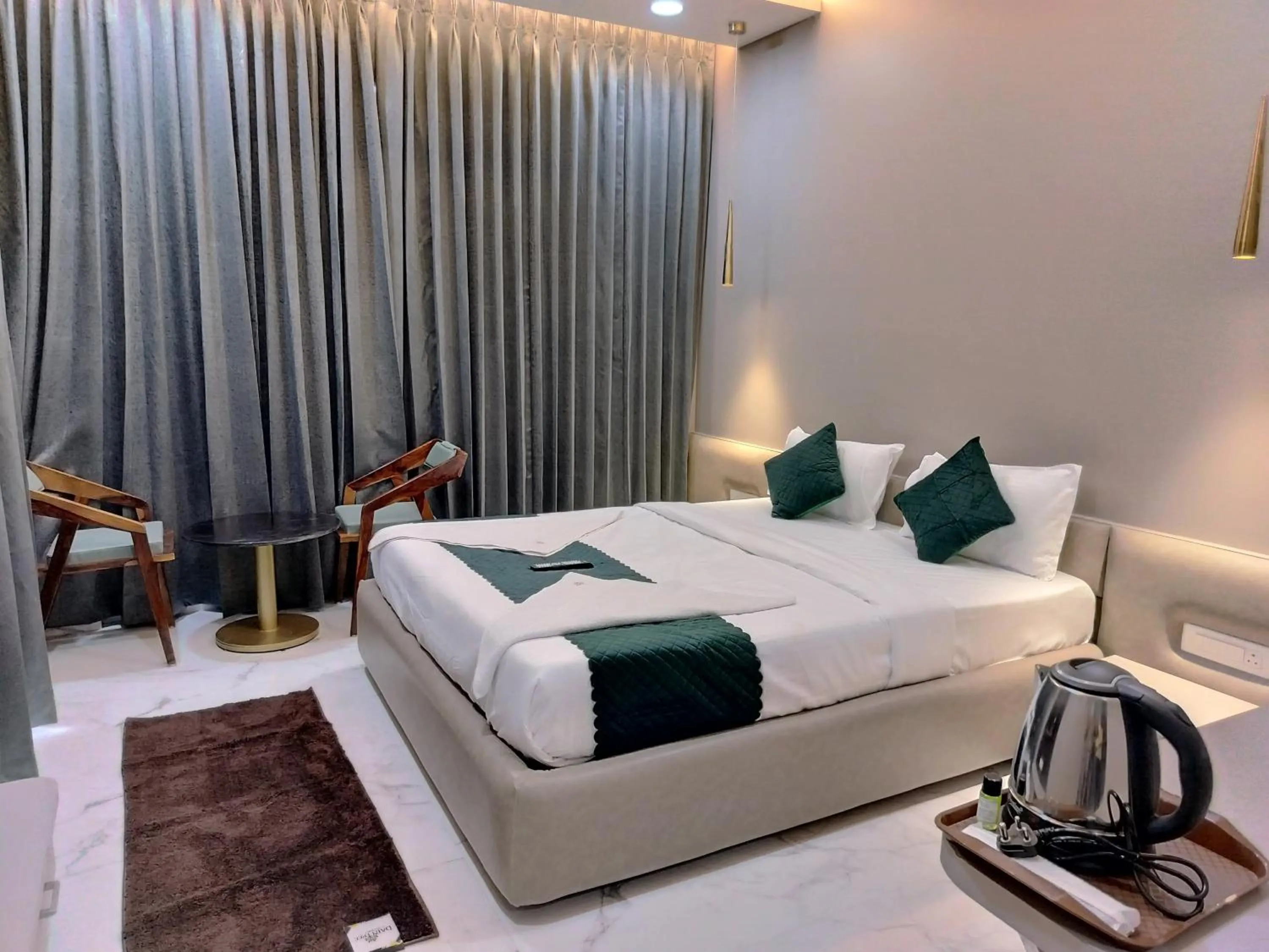 Seating area, Bed in Hotel Laxmi Elite Karad