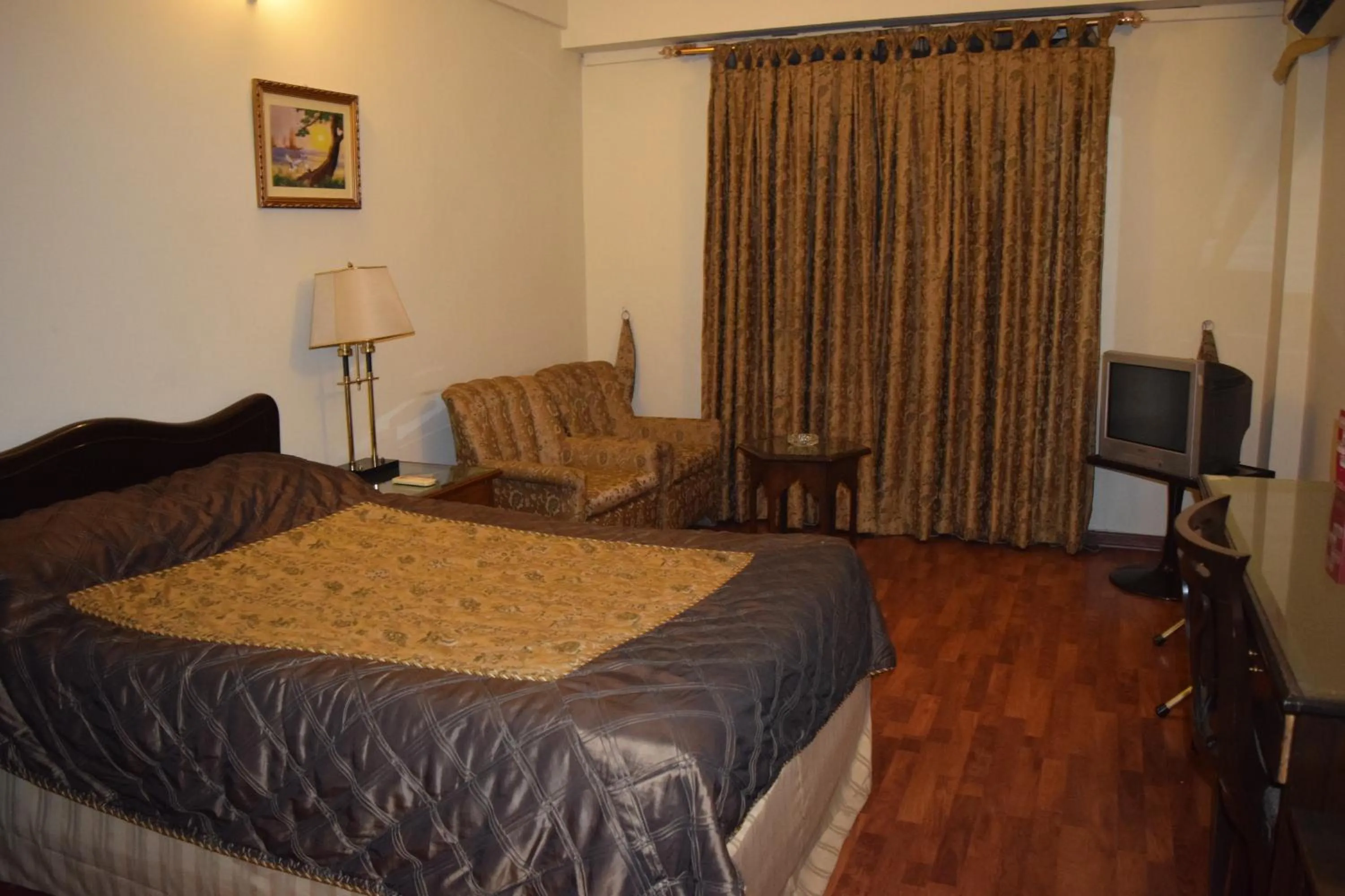 Seating area, Bed in Carlton Tower Hotel Lahore