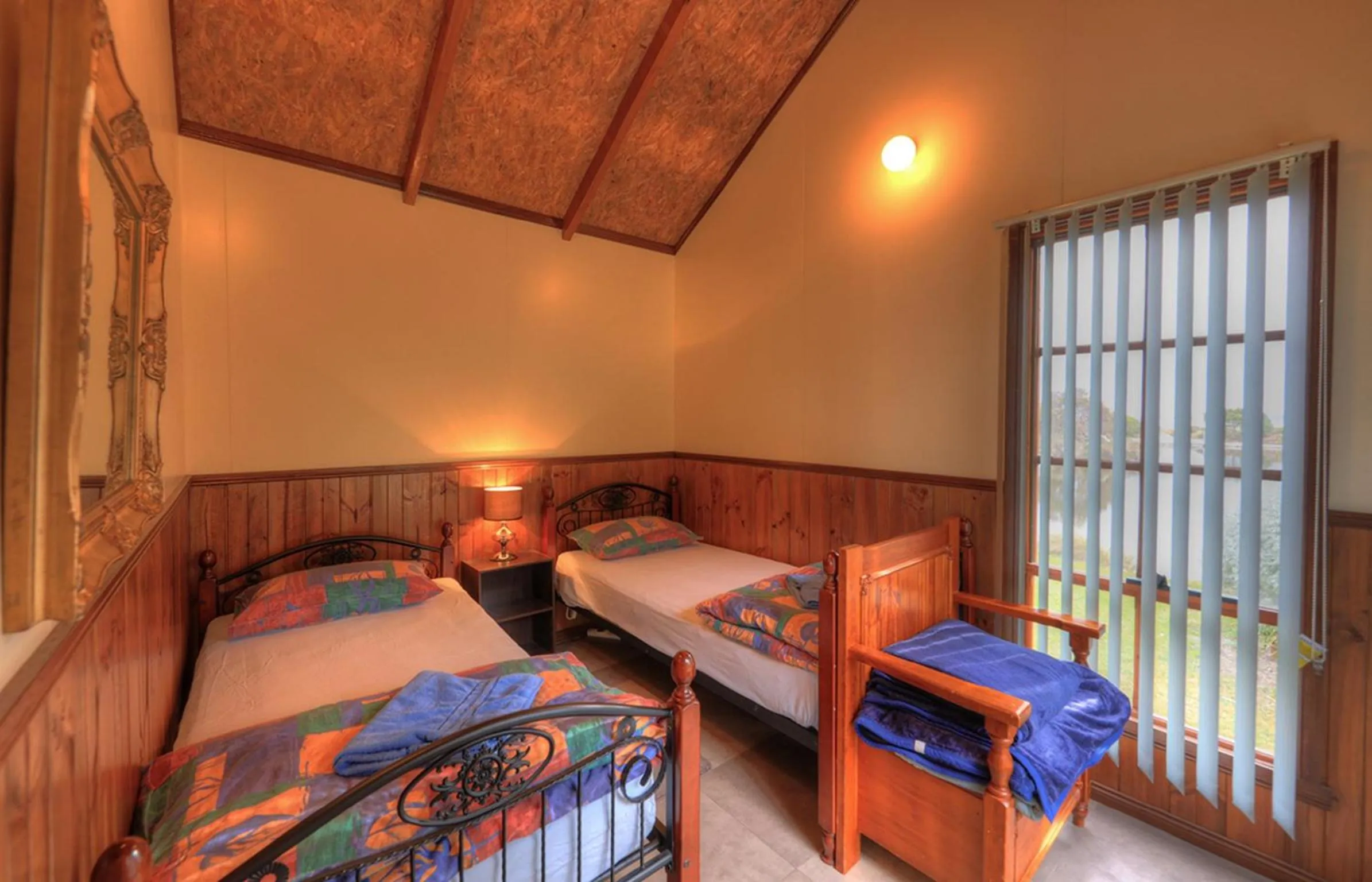 Bed in Stanley Lakeside Spa Cabins