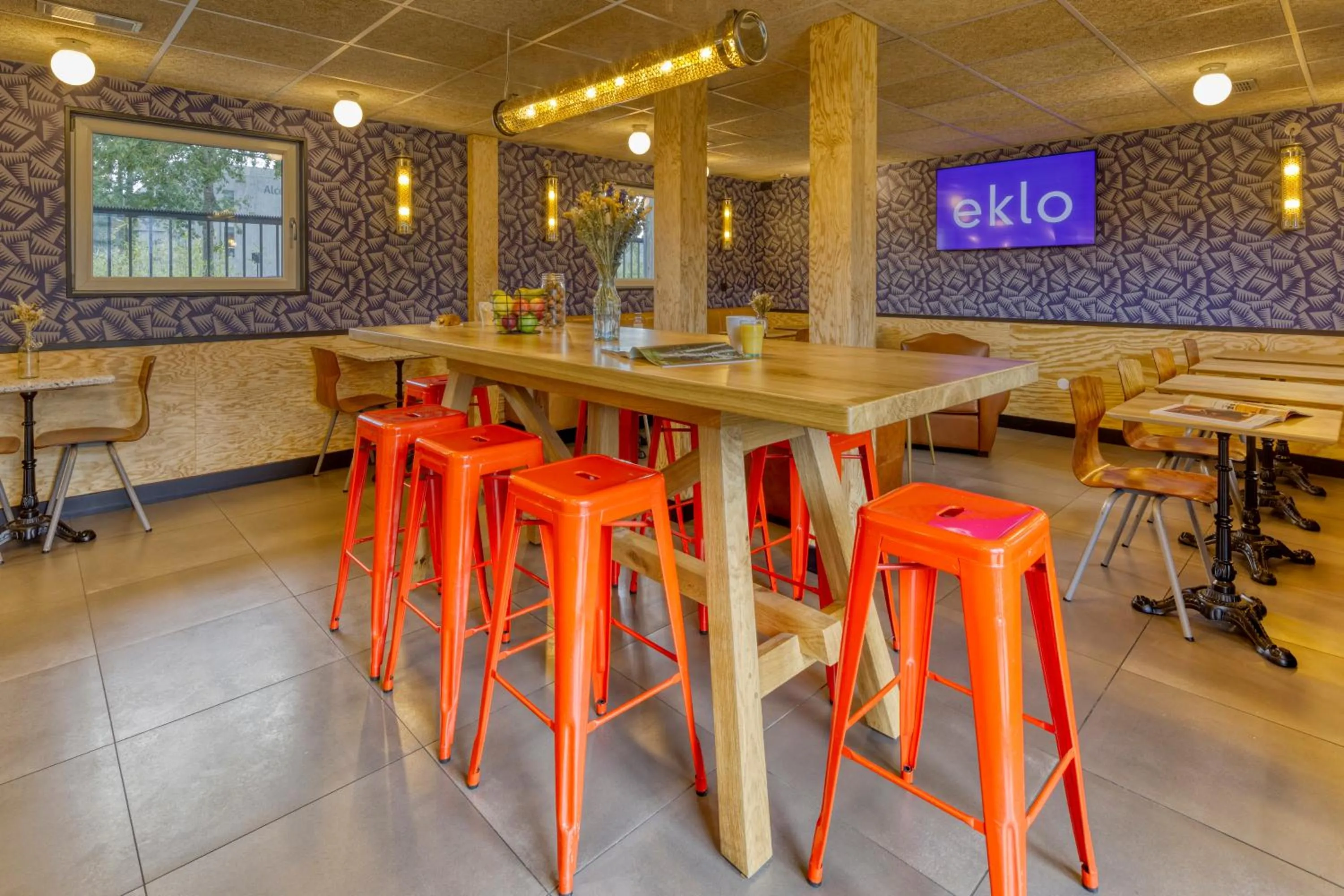 Communal lounge/ TV room in Eklo Hotels Le Havre